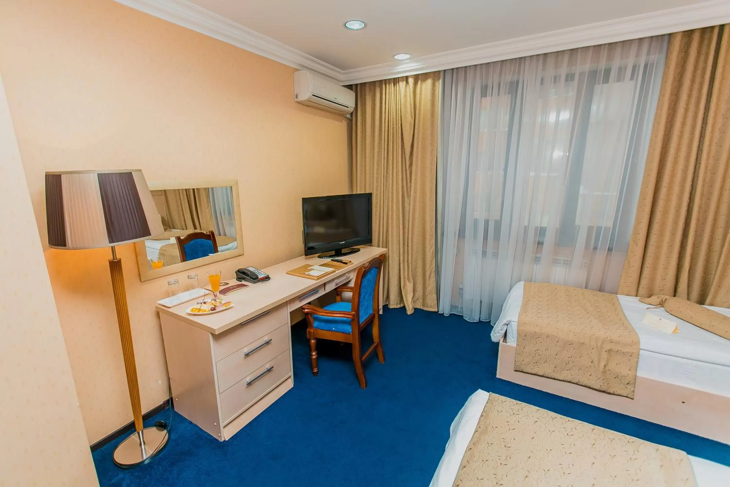 Bed, TV/Entertainment Center in King Hotel Astana