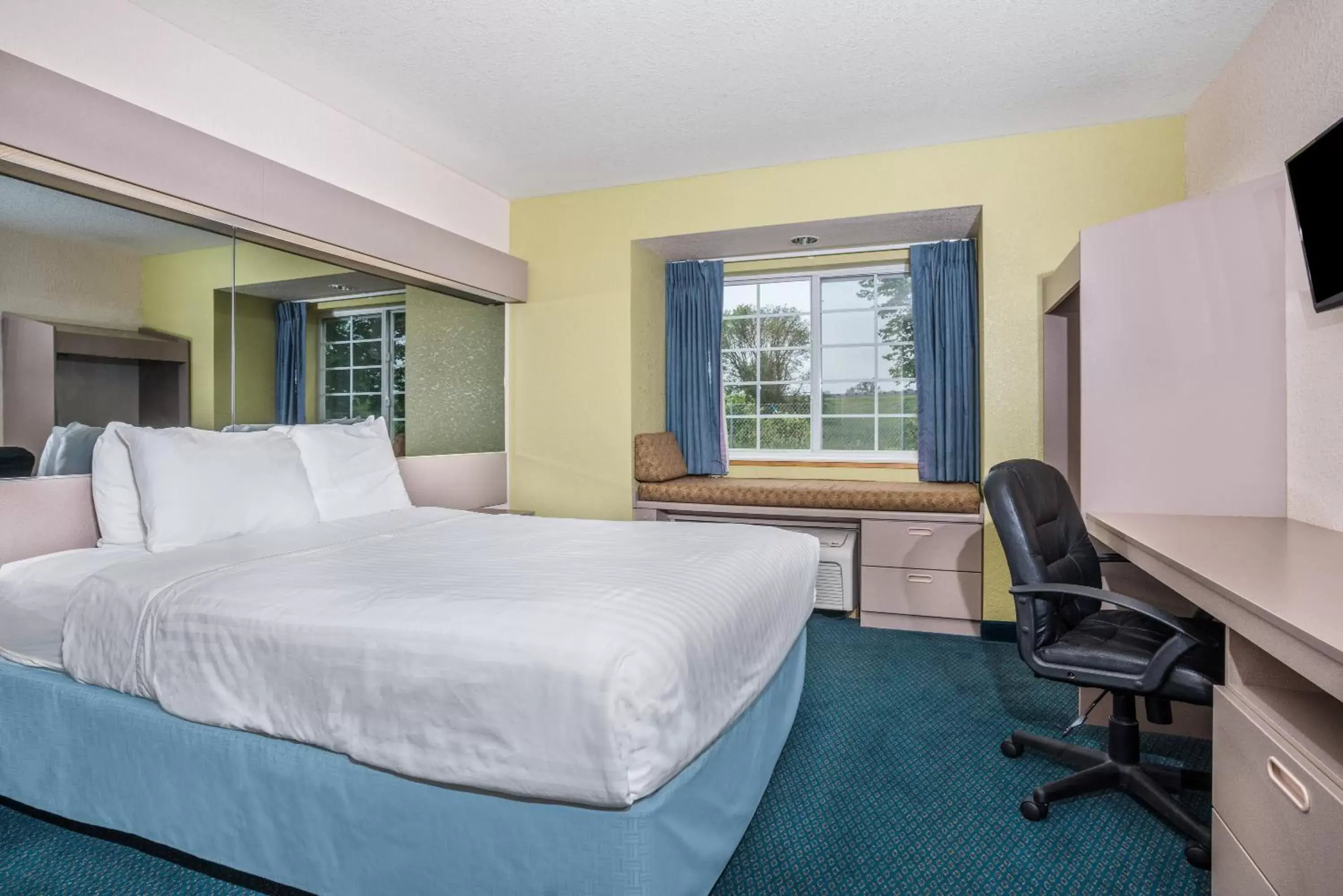 Seating area, Bed in Microtel Inn & Suites Tomah