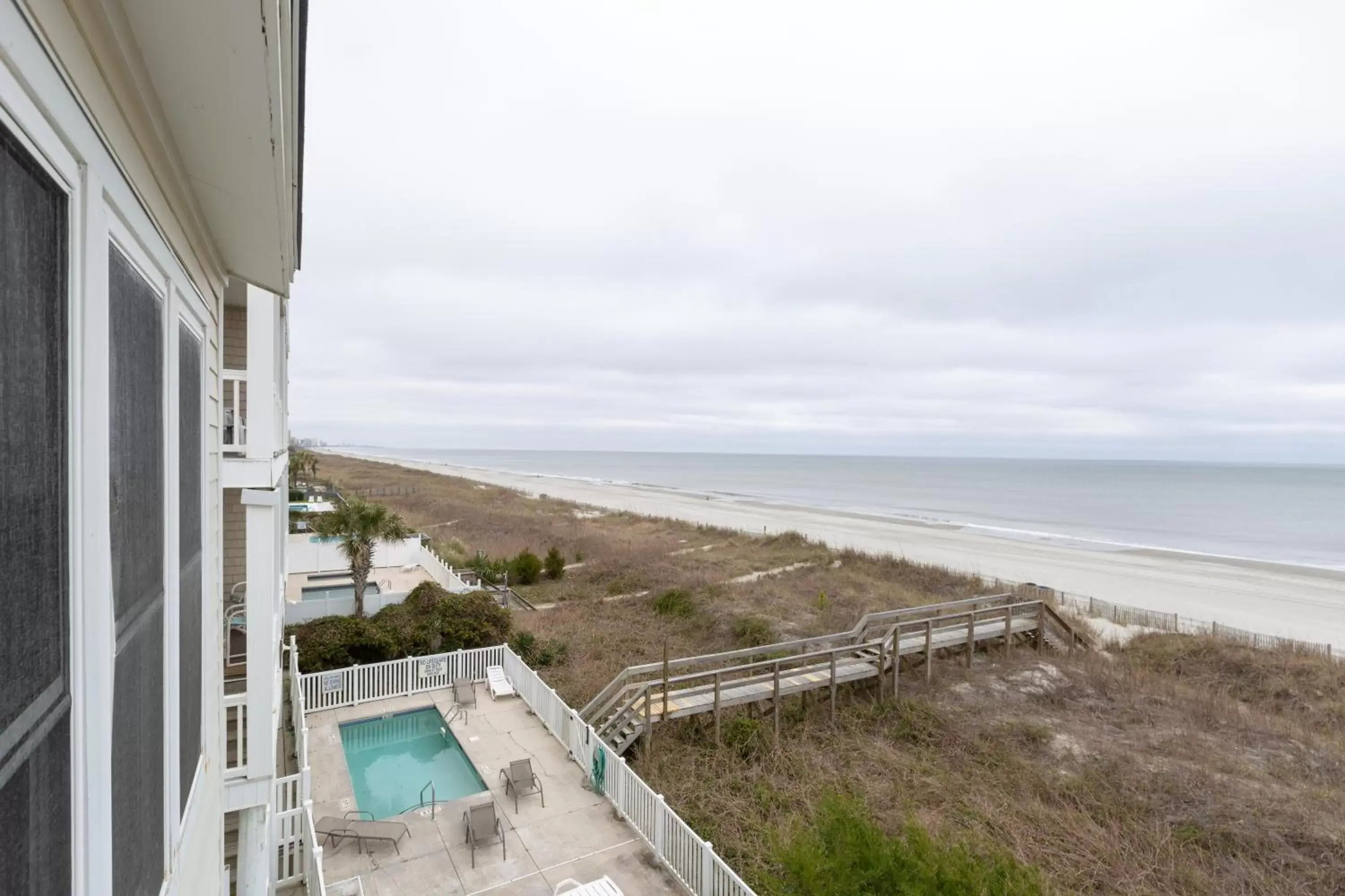 Balcony/Terrace, Pool View in A Place at the Beach by Capital Vacations