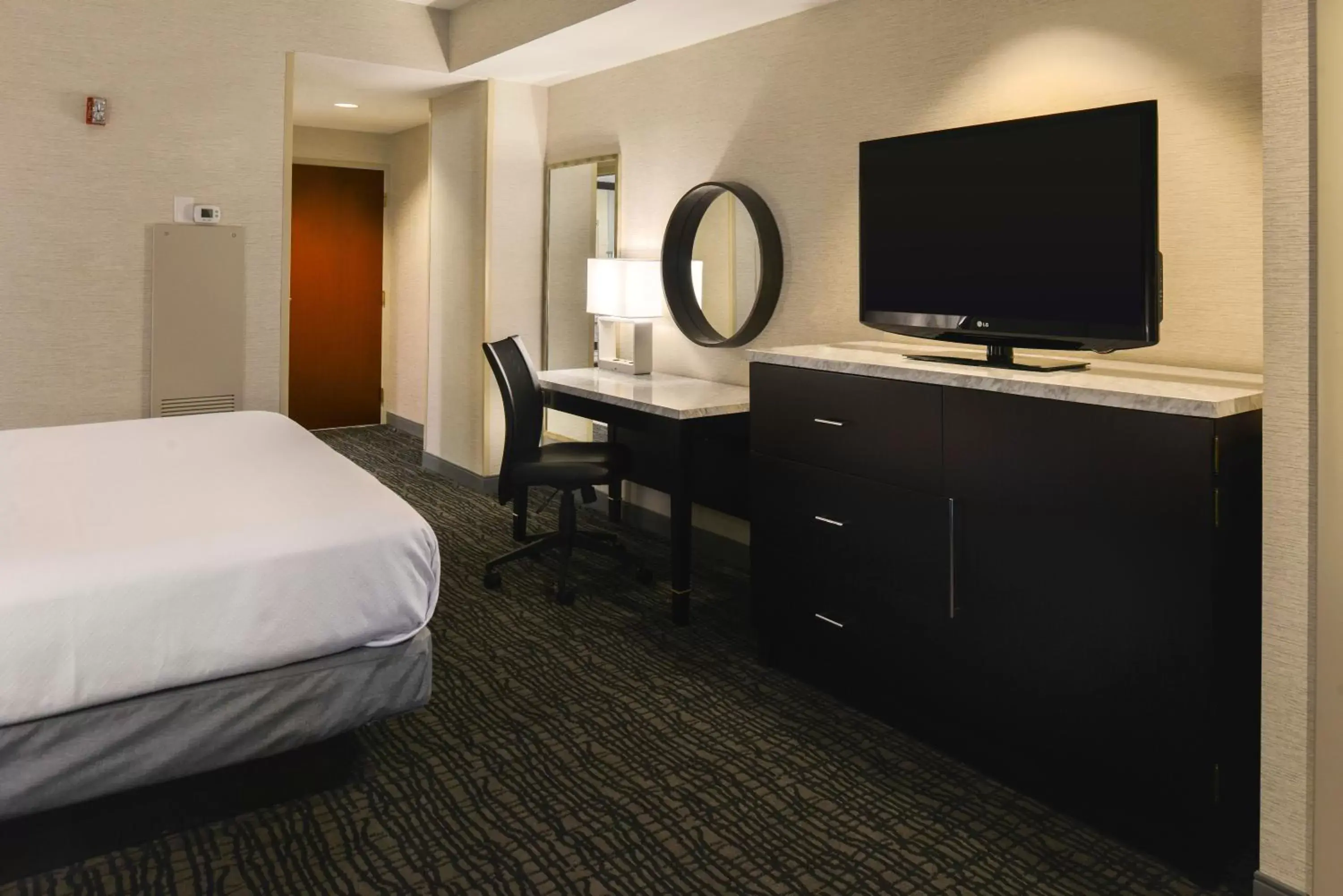 Photo of the whole room, TV/Entertainment Center in Crowne Plaza Springfield Convention Center, an IHG Hotel