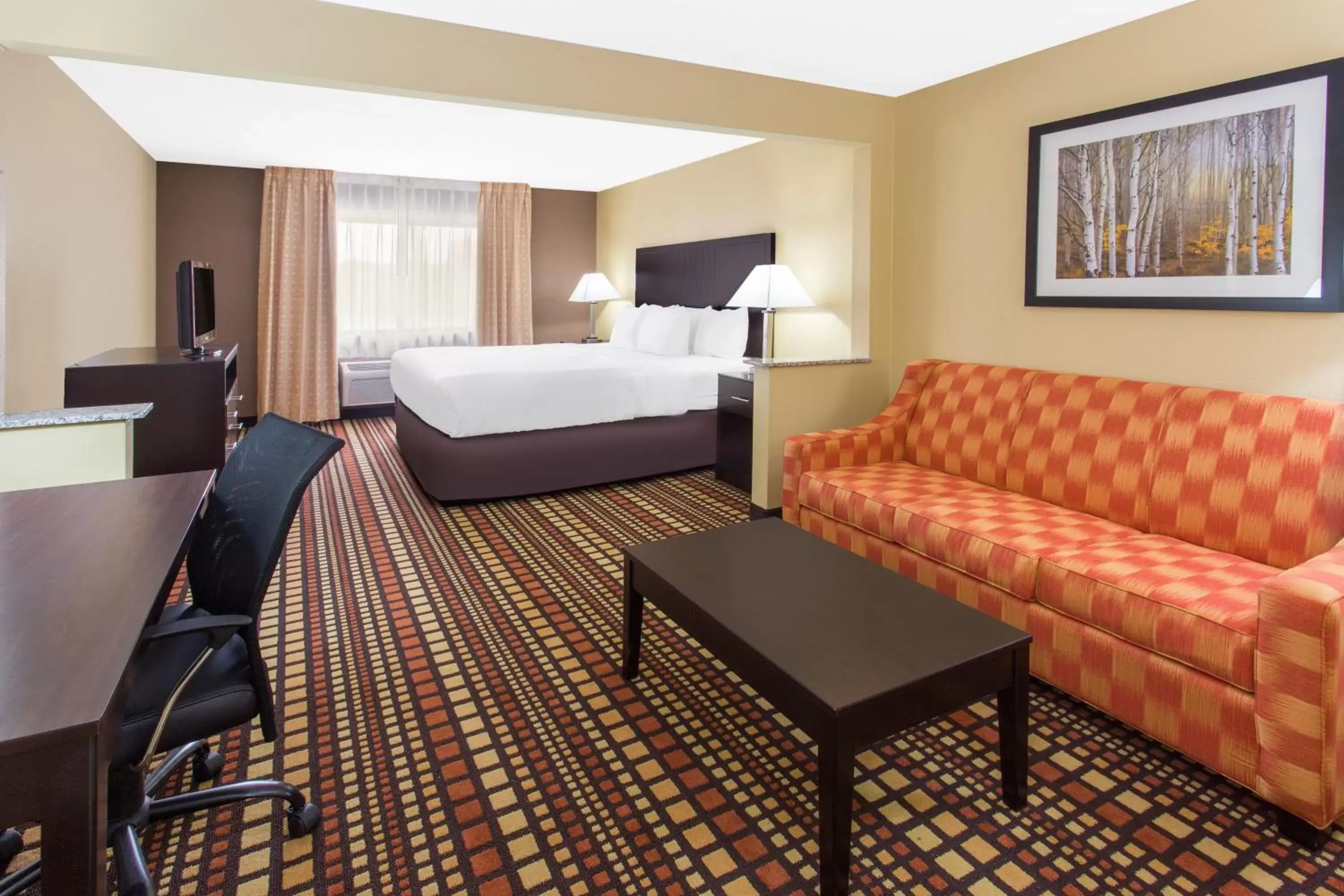 Bedroom, Seating Area in Days Inn & Suites by Wyndham Davenport East