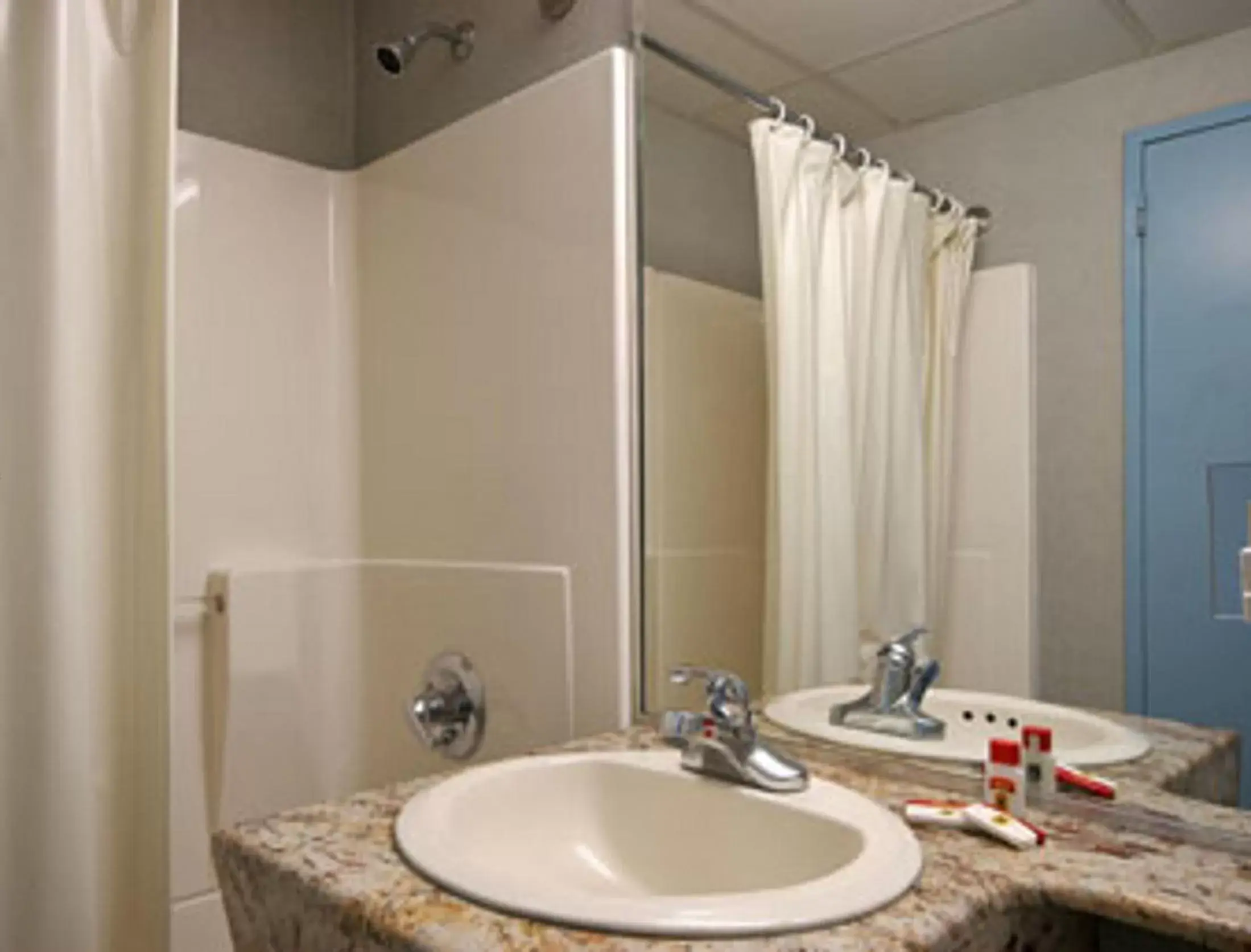 Bathroom in Super 8 by Wyndham Long Island City LGA Hotel