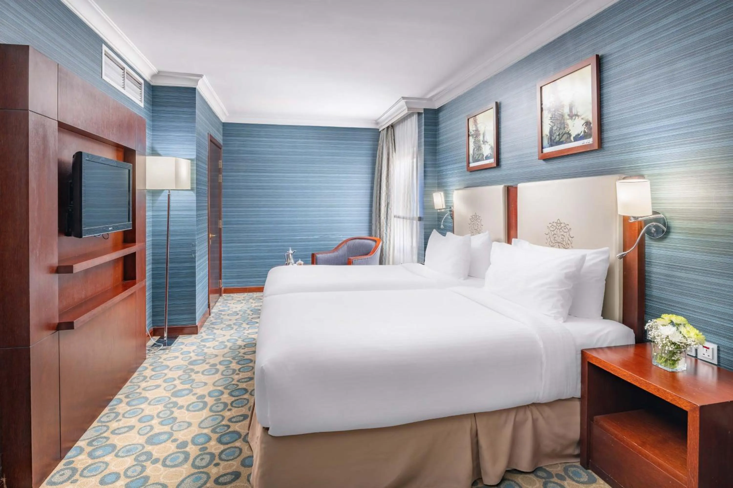 Bed in Millennium Al Aqeeq Hotel