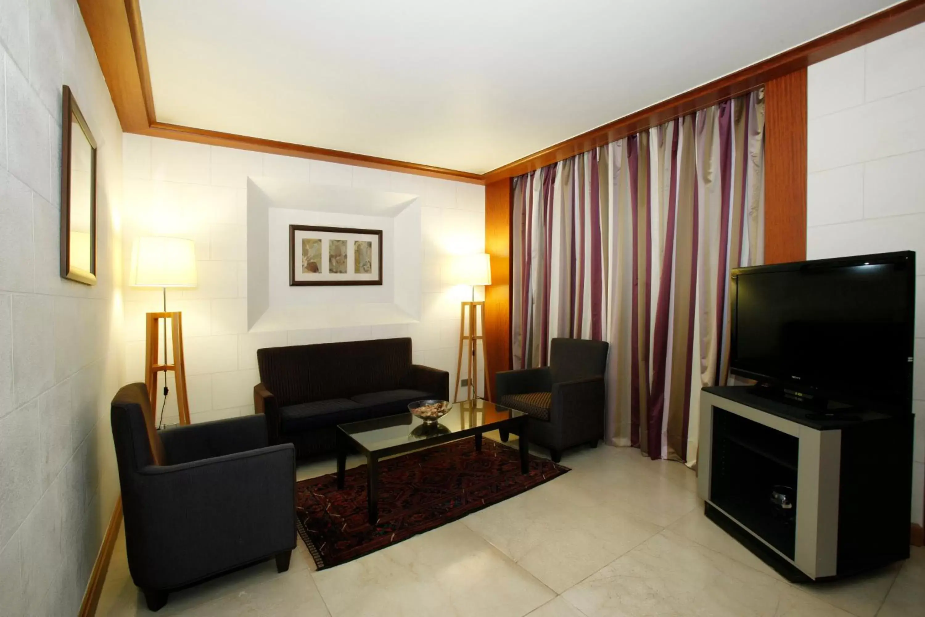 Photo of the whole room, TV/Entertainment Center in Crowne Plaza Hamra Beirut, an IHG Hotel