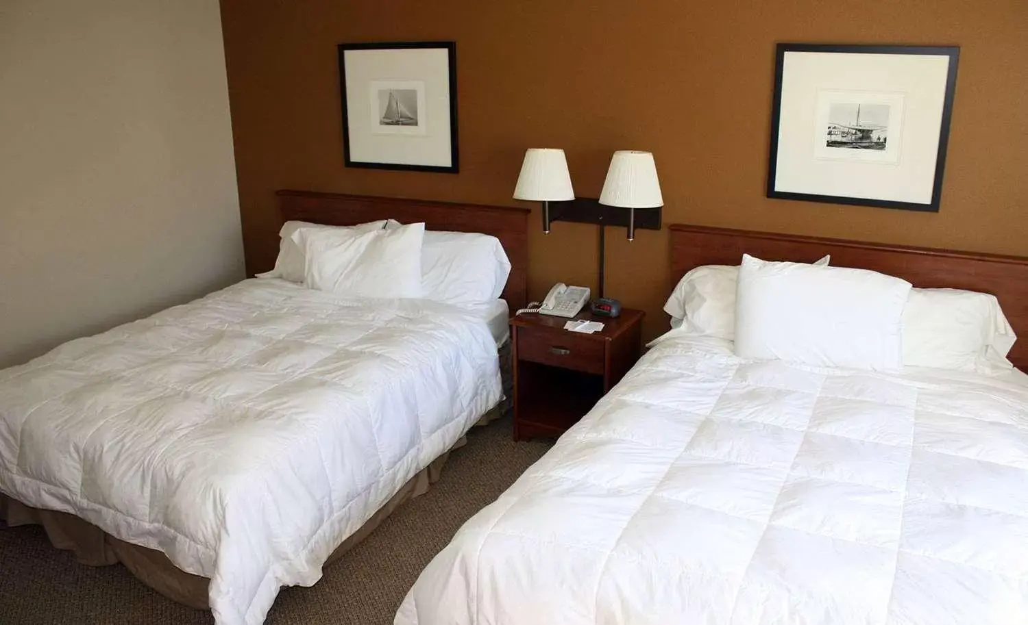 Bed in AmericInn by Wyndham Charlevoix