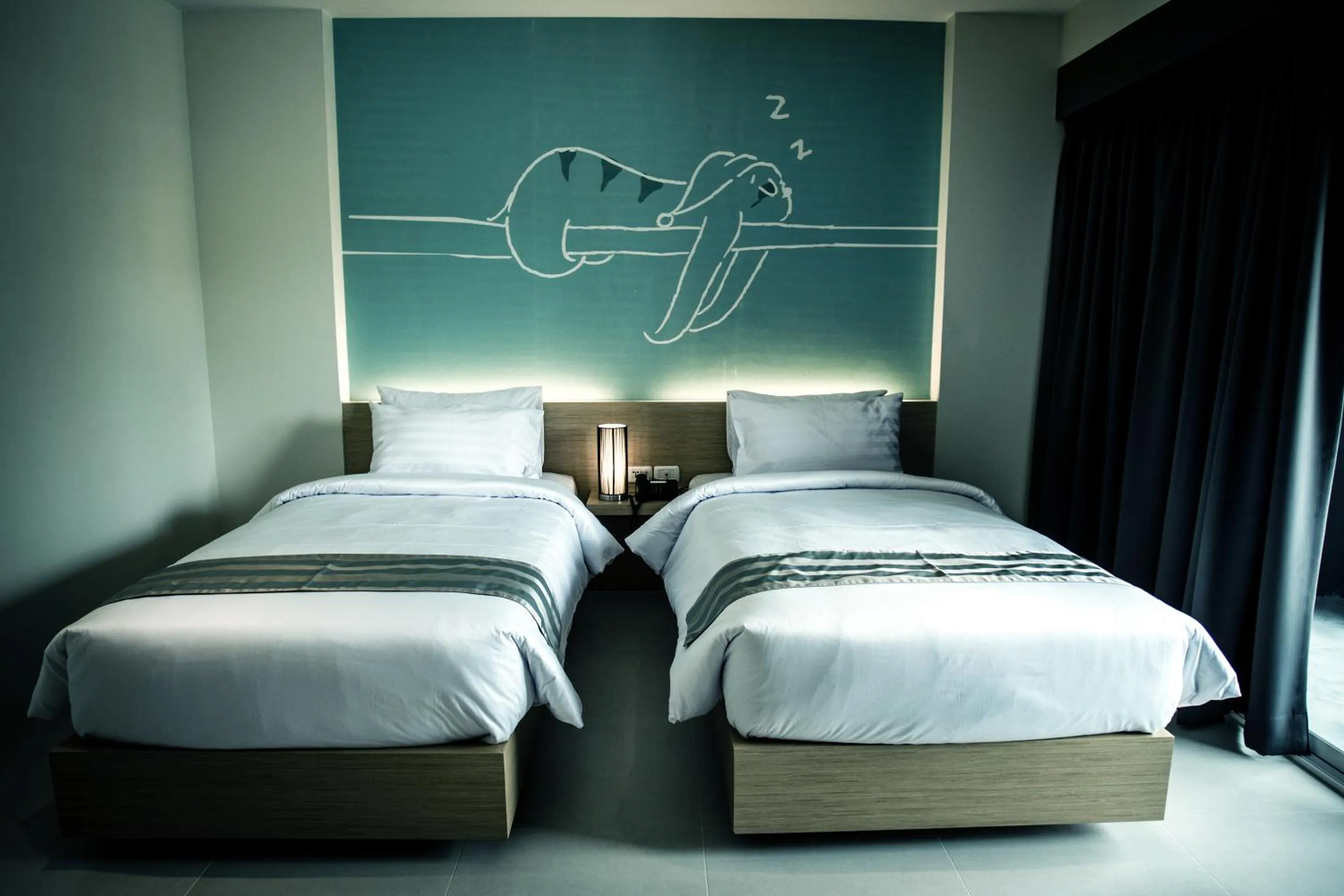 Bed in TIRAS Patong Beach Hotel