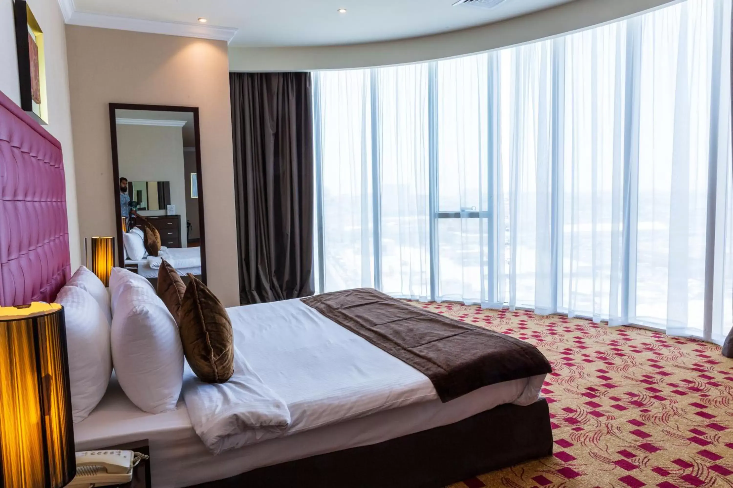 Photo of the whole room, Bed in Kingsgate Hotel Doha by Millennium Hotels.