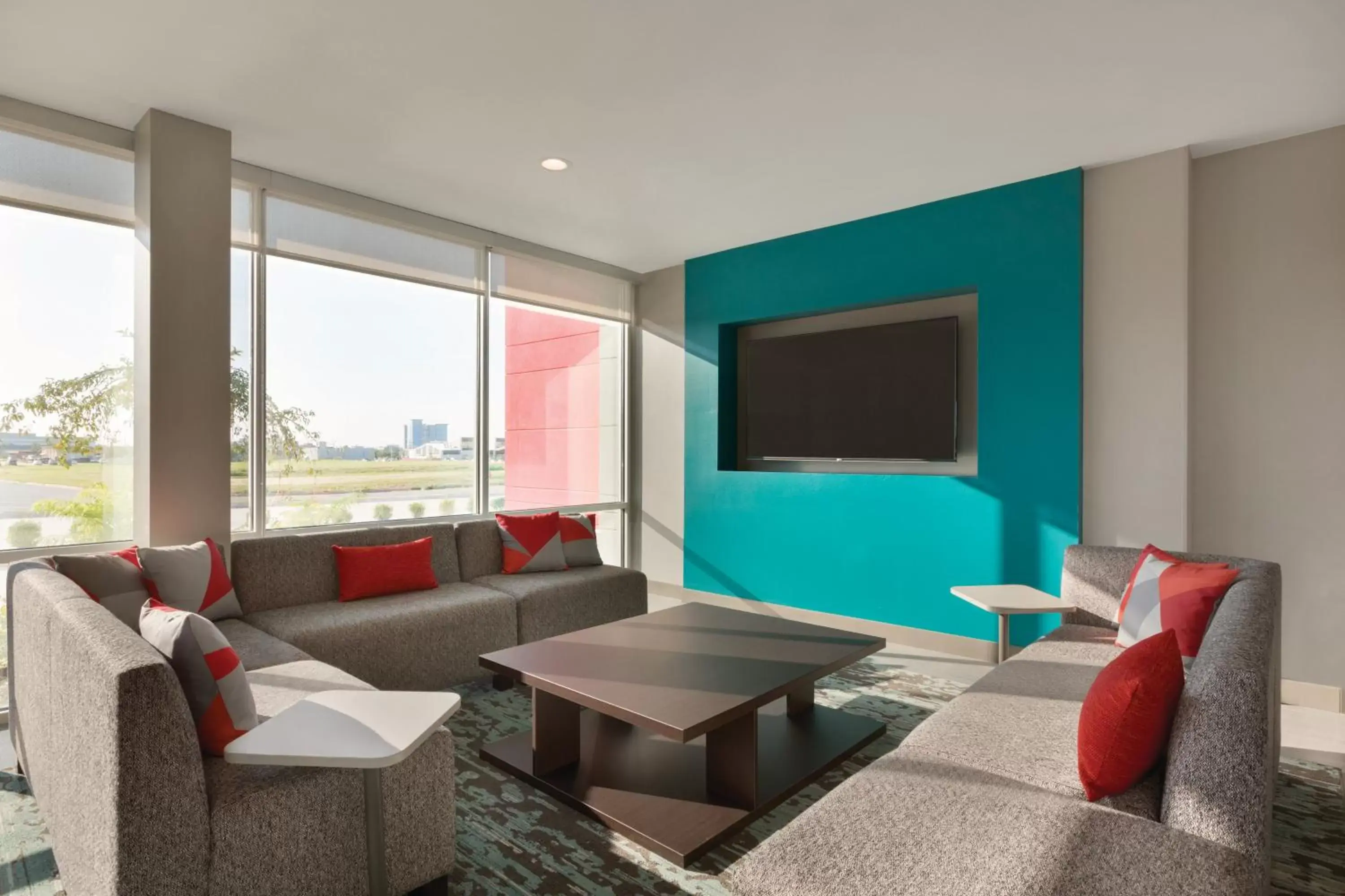 Communal lounge/ TV room, Seating Area in avid Hotel - Toronto - Vaughan Southwest, an IHG Hotel
