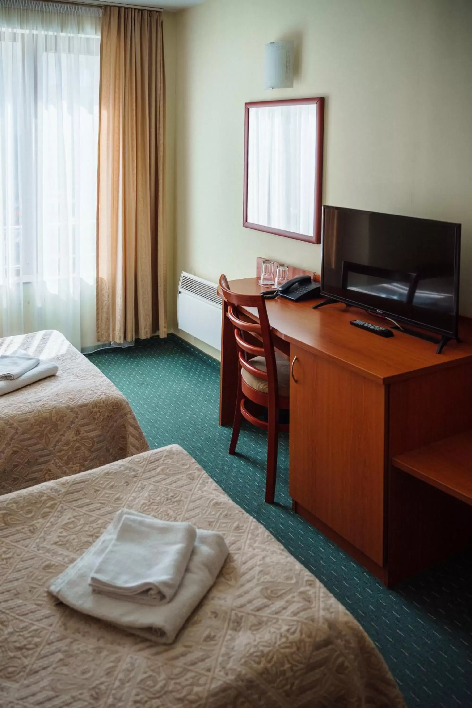 Bed, TV/Entertainment Center in Dionis Hotel