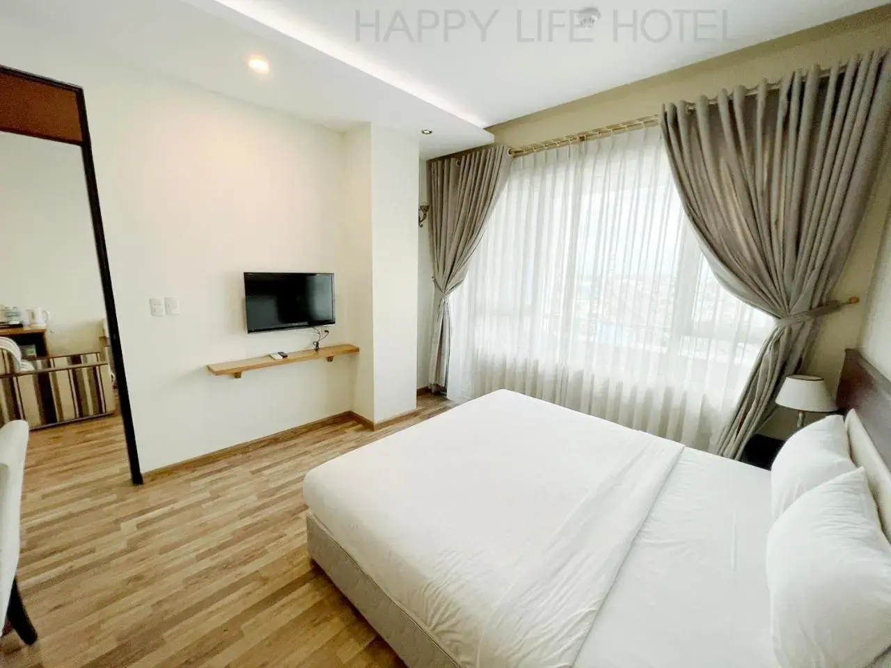 Communal lounge/ TV room, TV/Entertainment Center in Happy Life Hotel