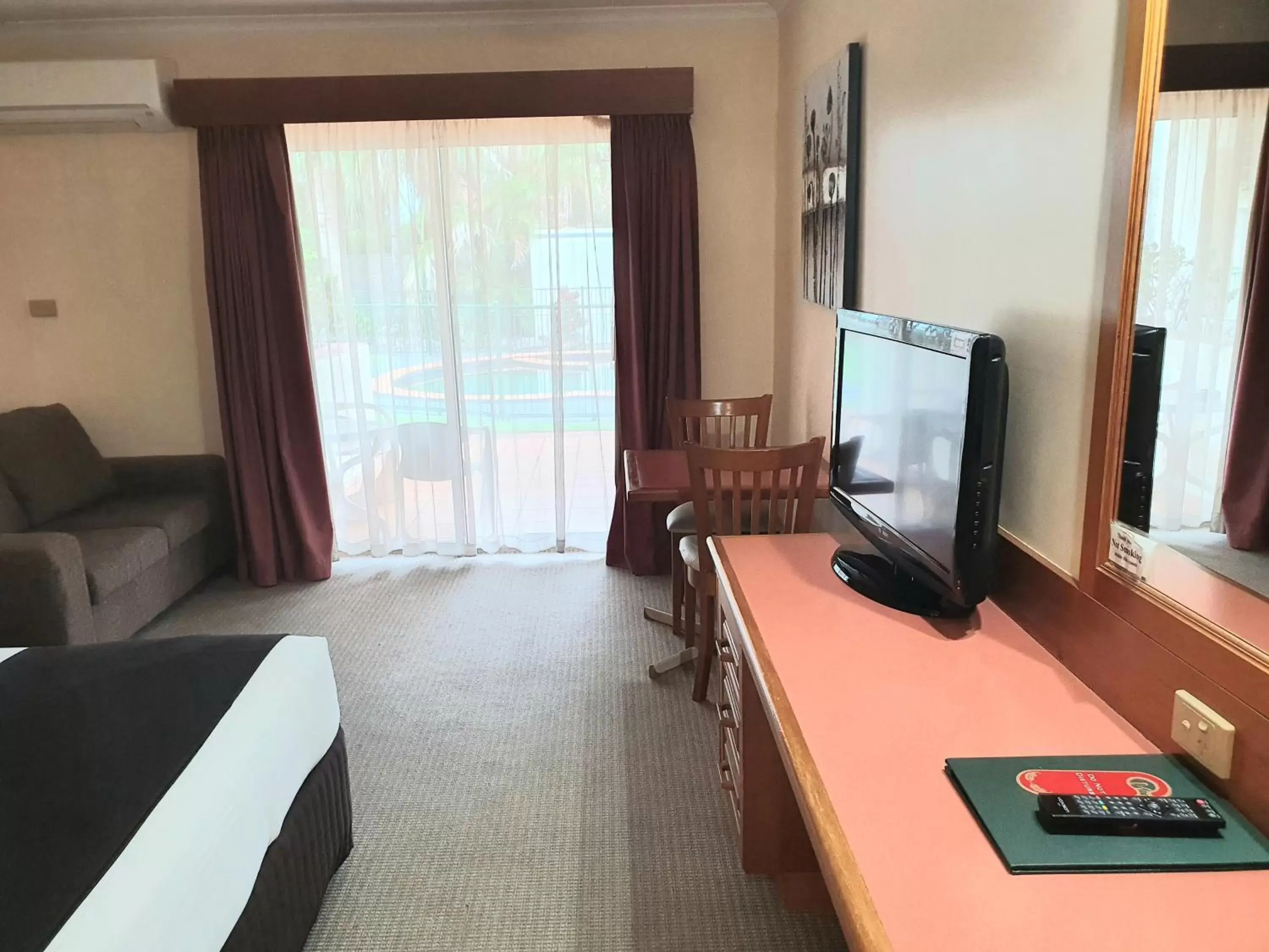 Pool view, TV/Entertainment Center in McNevins Maryborough Motel