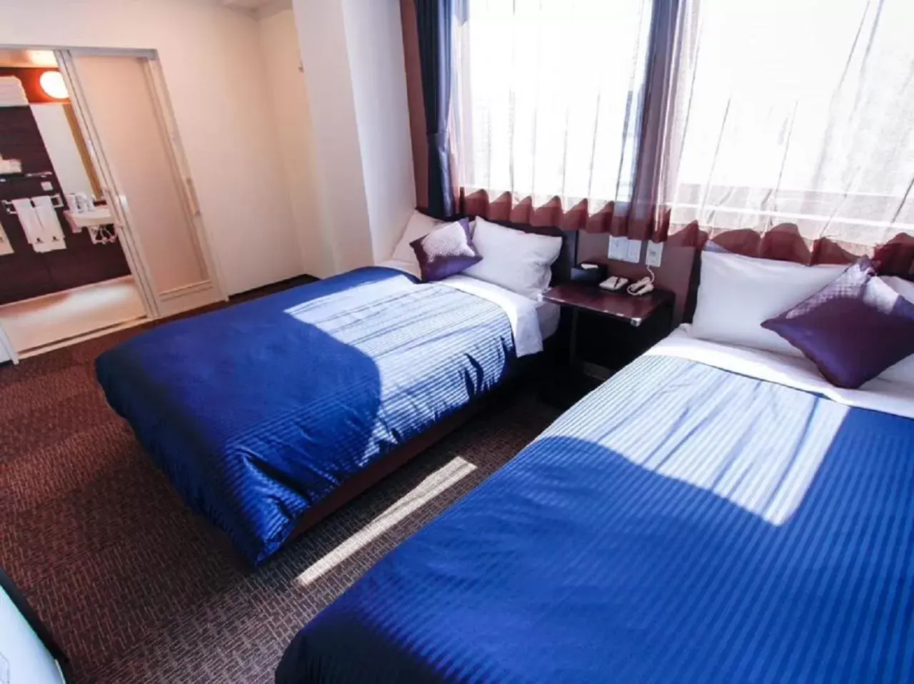 Bed in HOTEL LiVEMAX Osaka Dome Mae Hotel