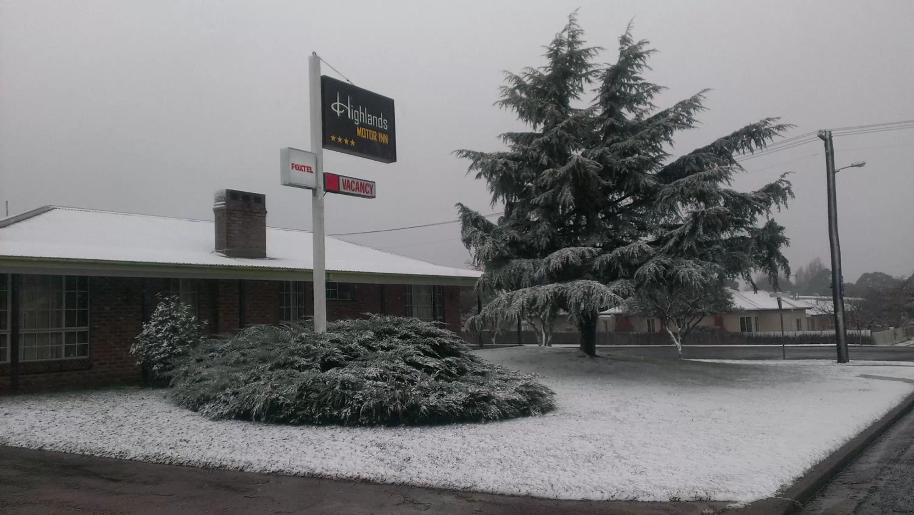 Property logo or sign in Highlands Motor Inn