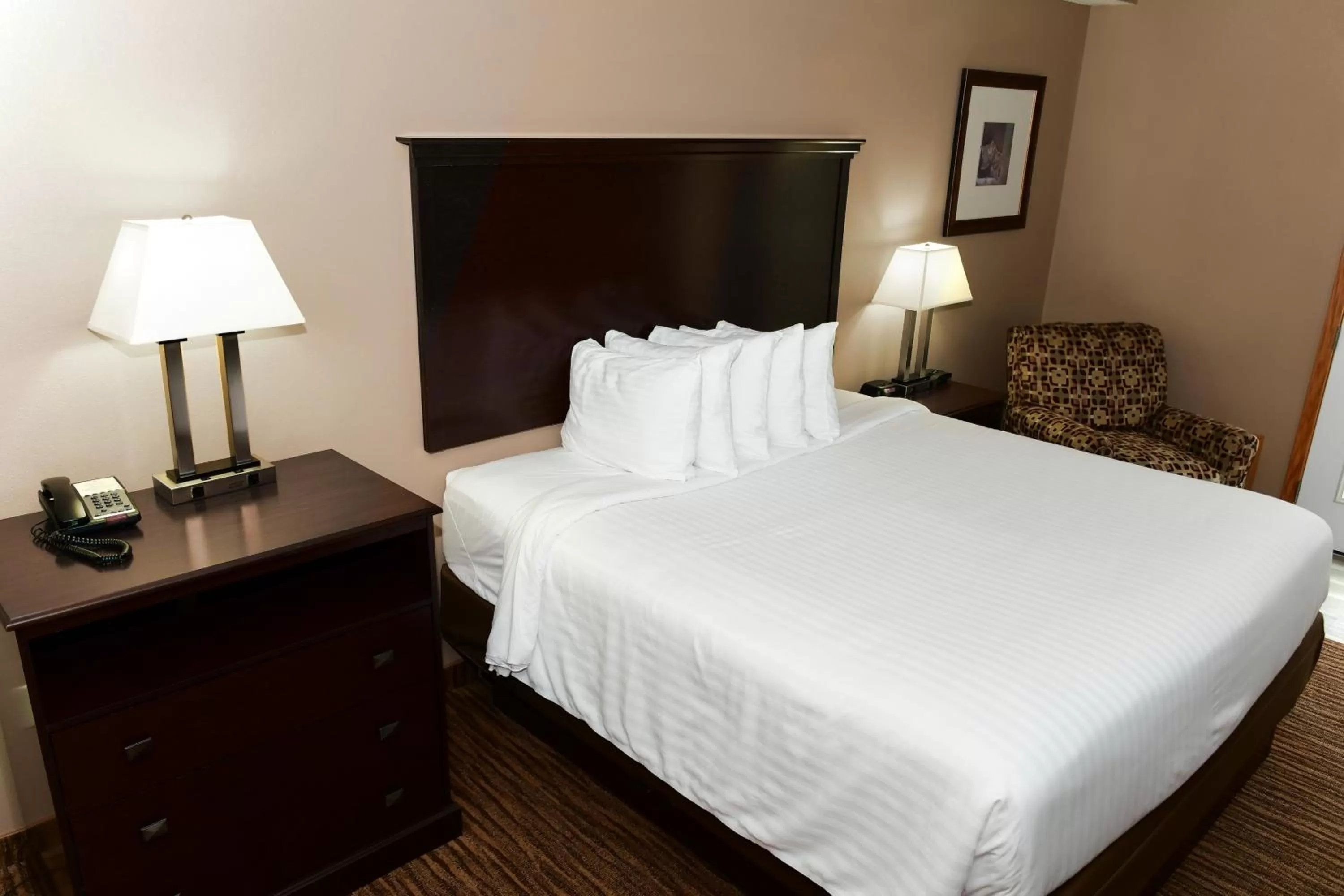 Bed in Cobblestone Inn & Suites - Denison | Majestic Hills