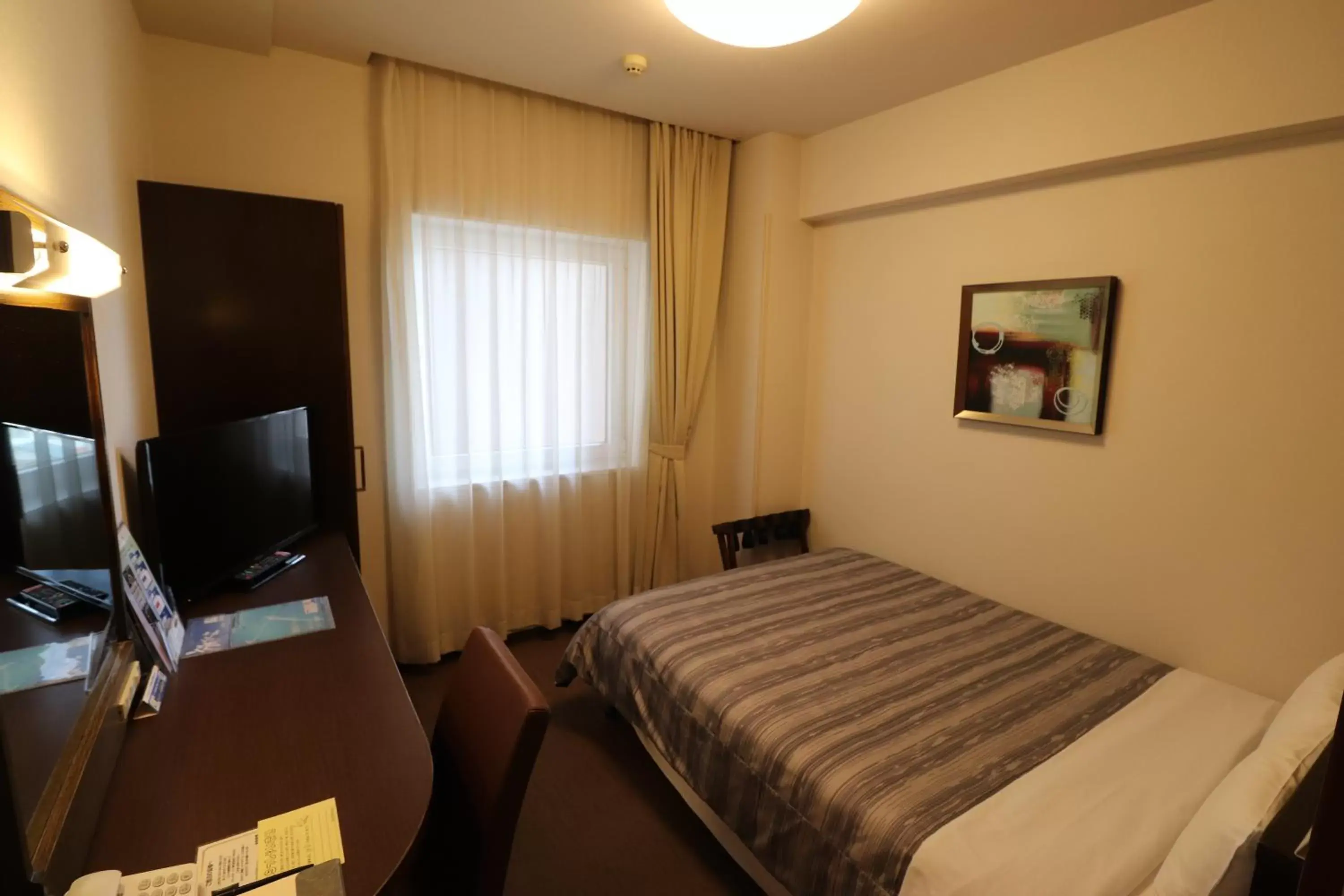 Bed in Hotel Route-Inn Chitose Ekimae Bed in Hotel Route-Inn Chitose Ekimae