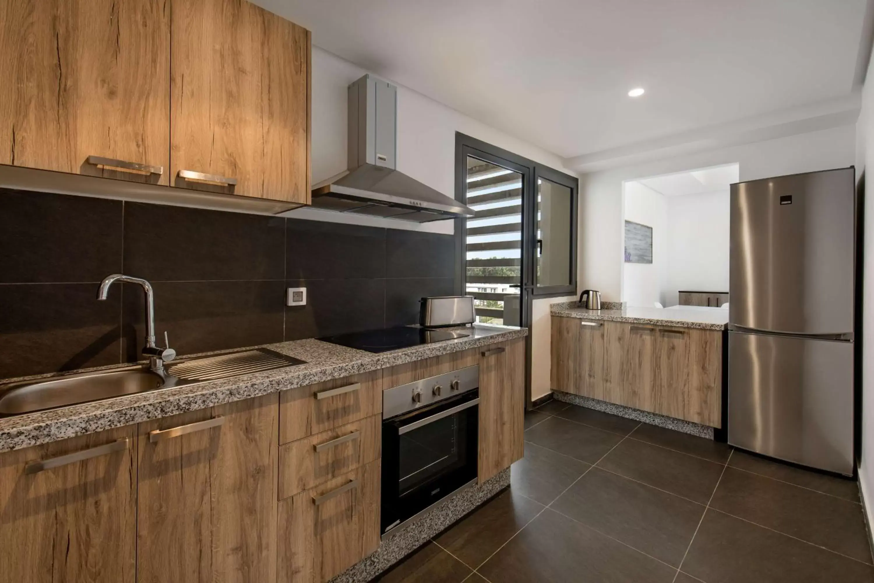 Photo of the whole room, Kitchen/Kitchenette in Radisson Blu Residences Al Hoceima