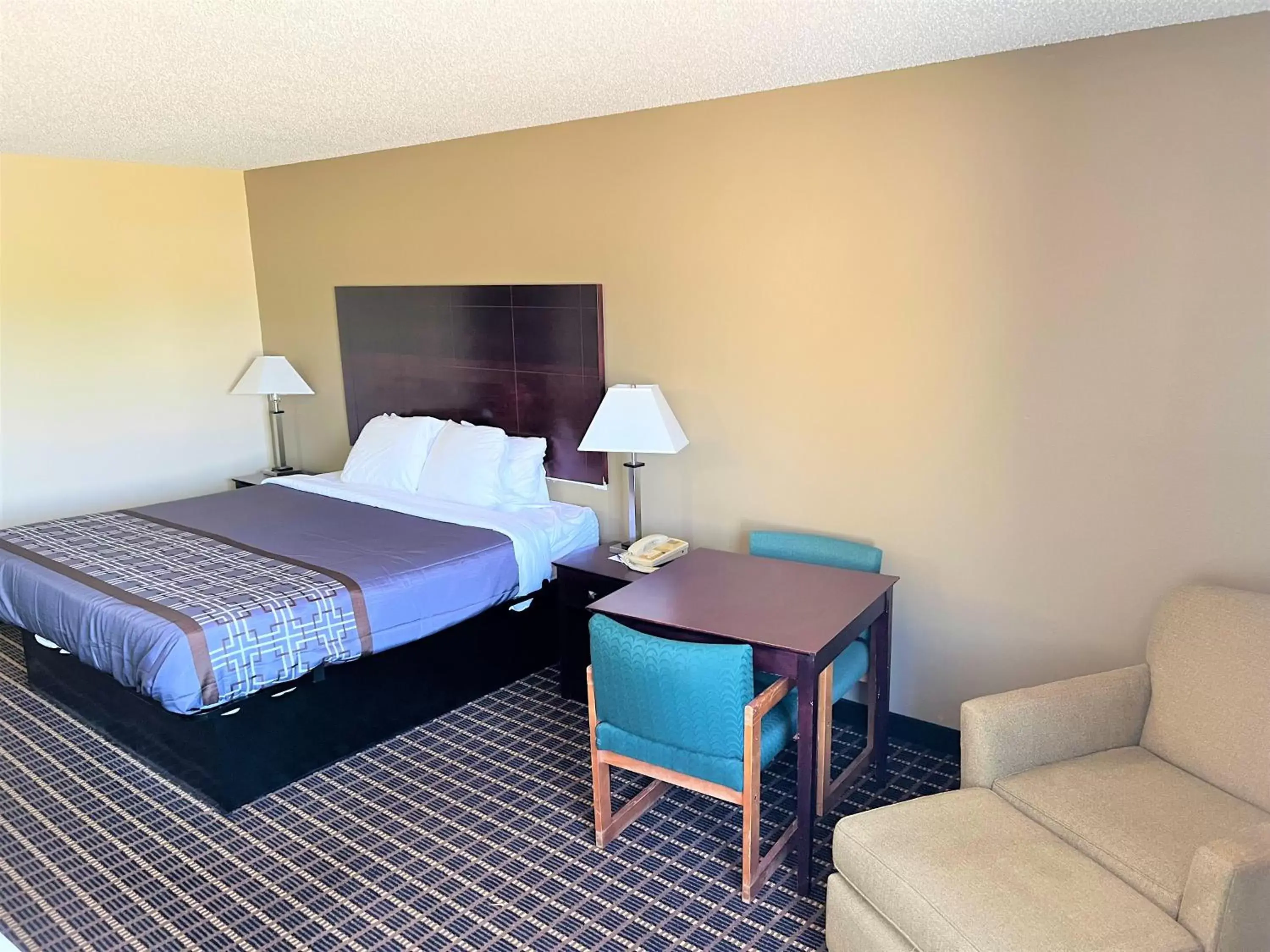 Bed in Designer Inn and Suites Bed in Designer Inn and Suites