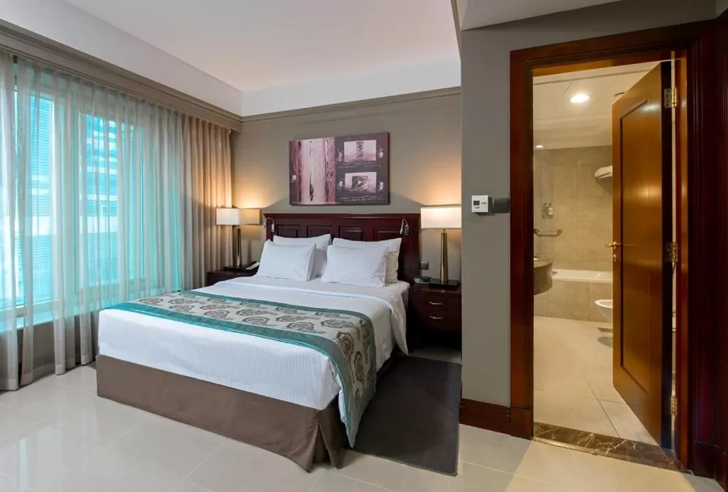 Bed in Somewhere Hotel Apartment