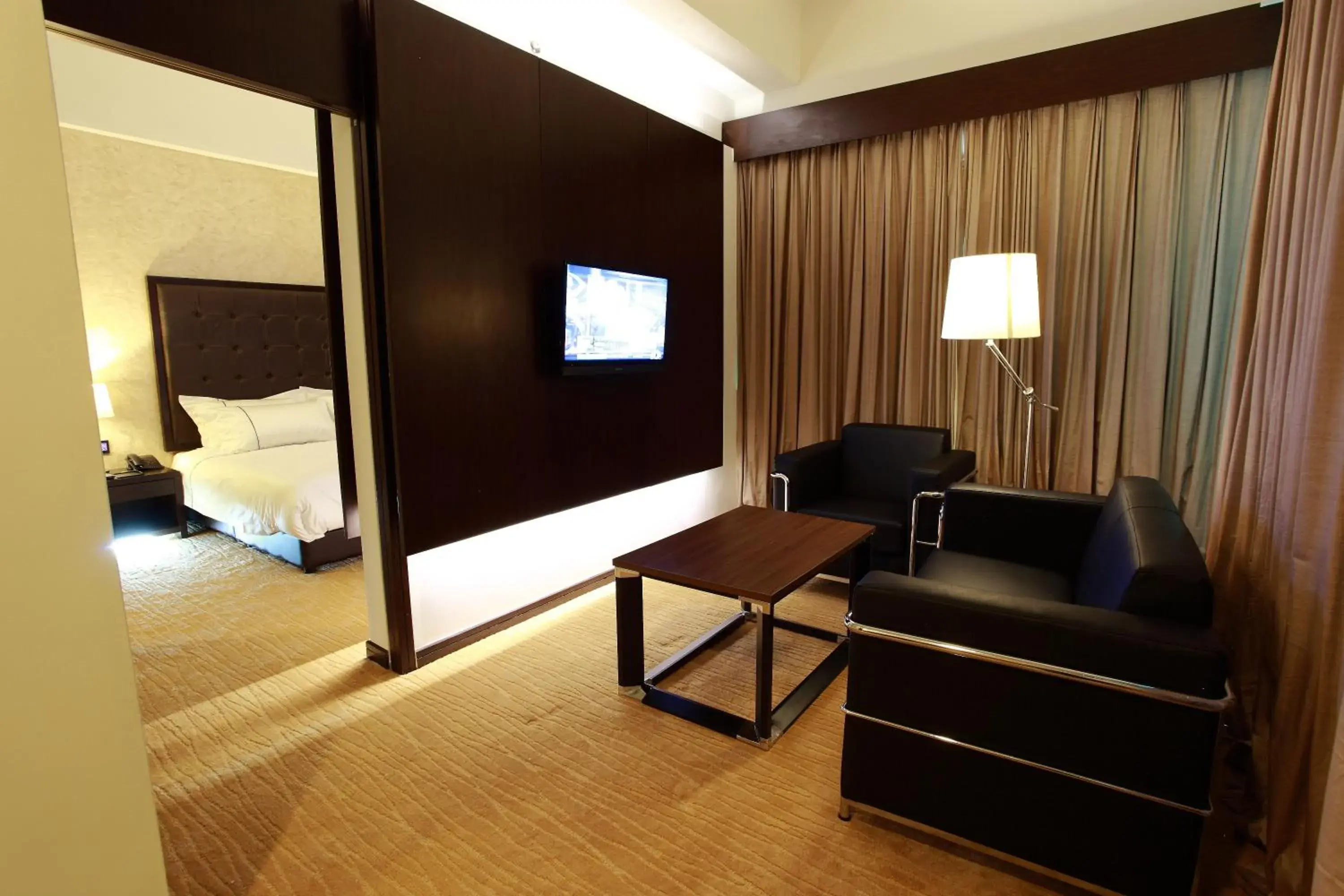 Living room, TV/Entertainment Center in Symphony Suites Hotel