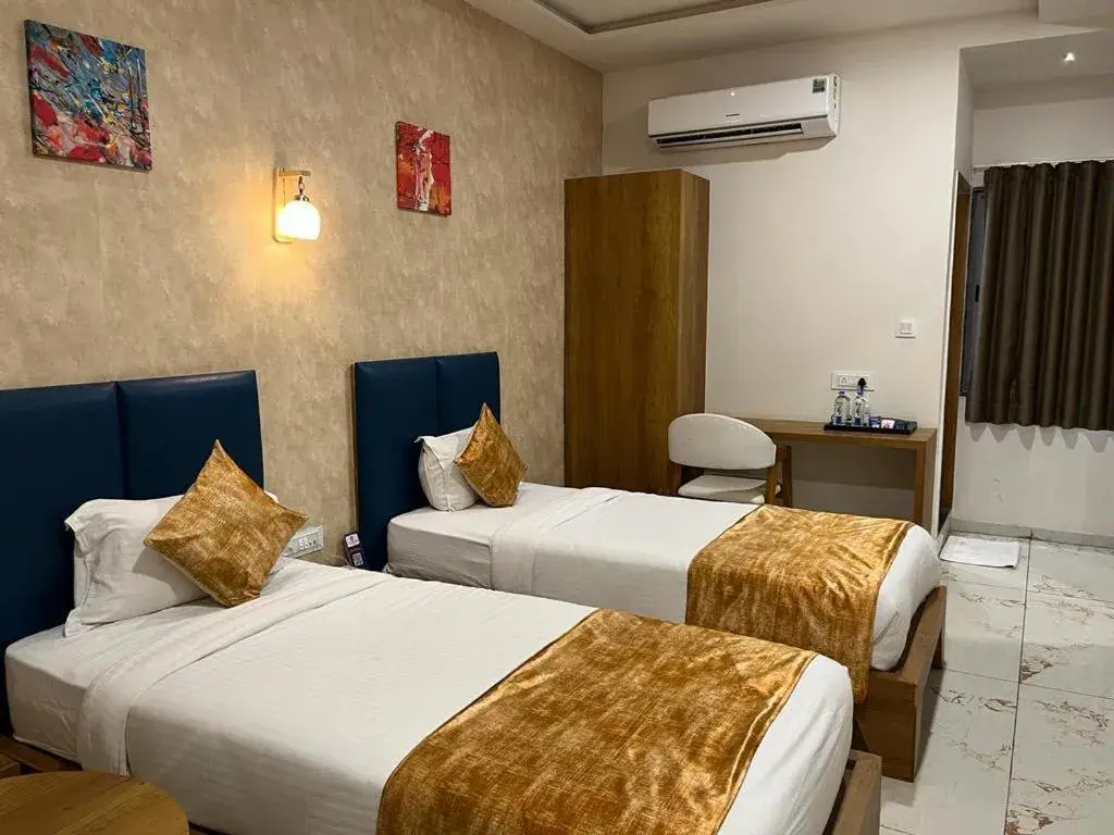 Bed in Click Hotel Tulsi