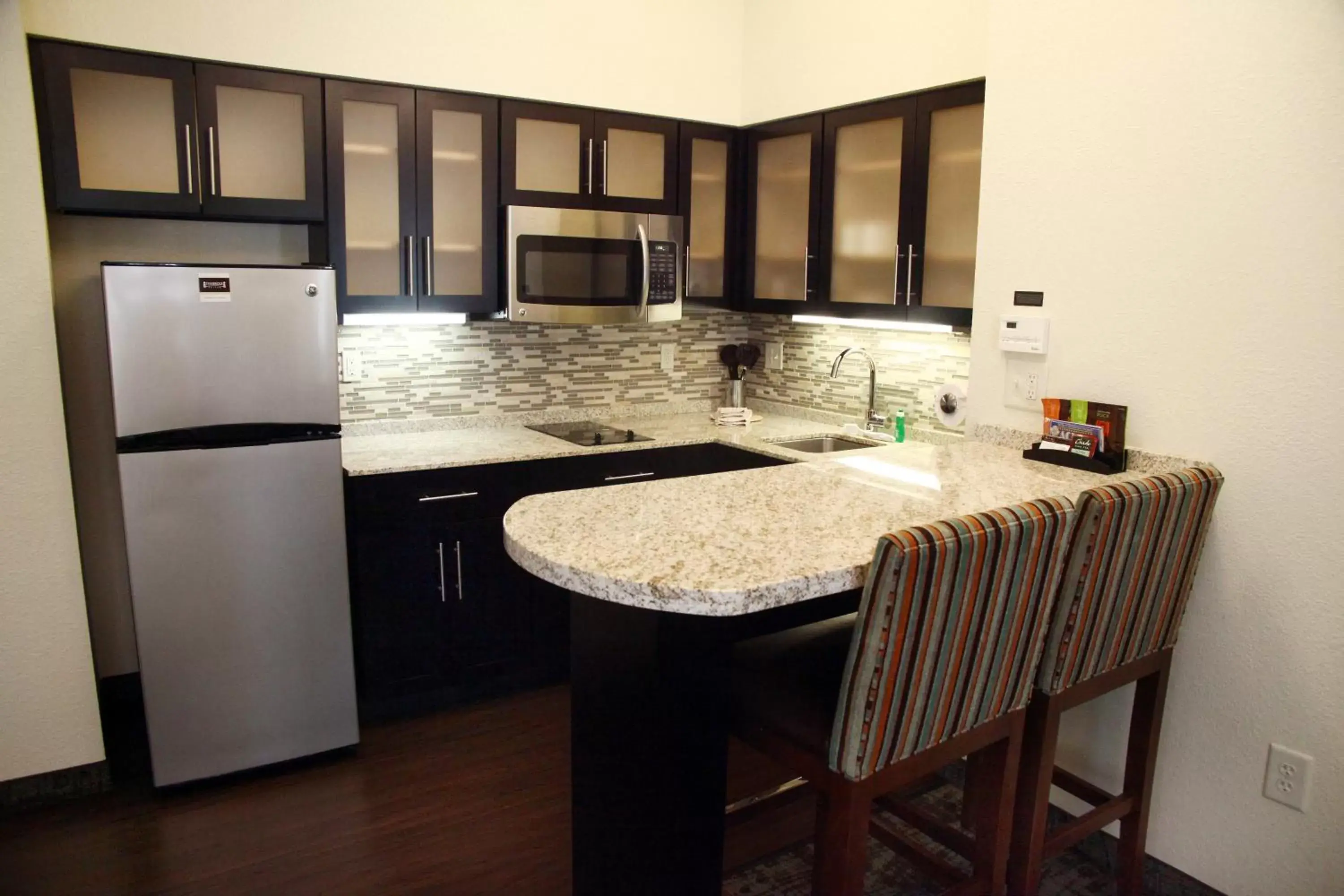 Photo of the whole room, Kitchen/Kitchenette in Staybridge Suites Minot, an IHG Hotel