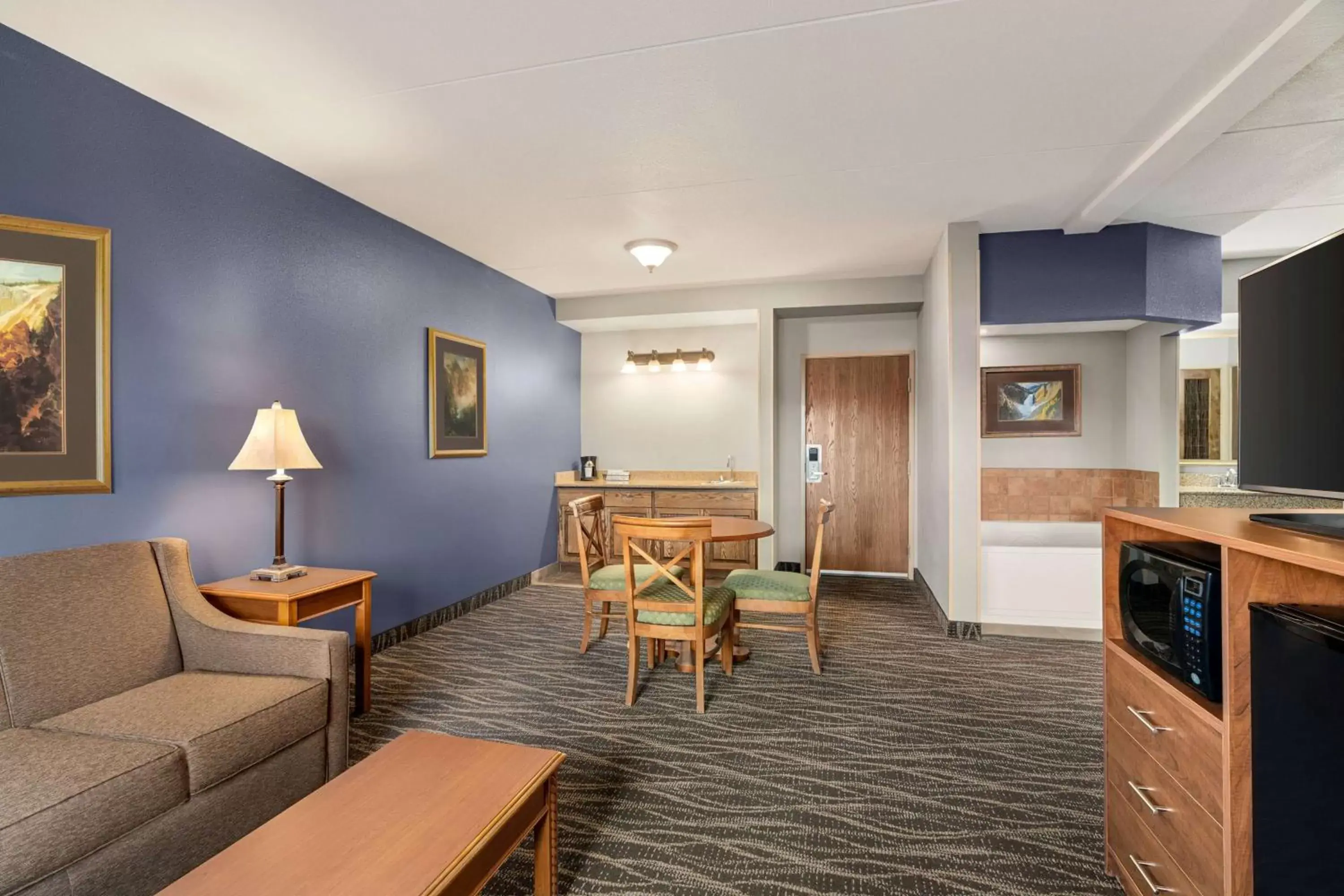 Bed, Seating Area in AmericInn by Wyndham Laramie Near University of Wyoming