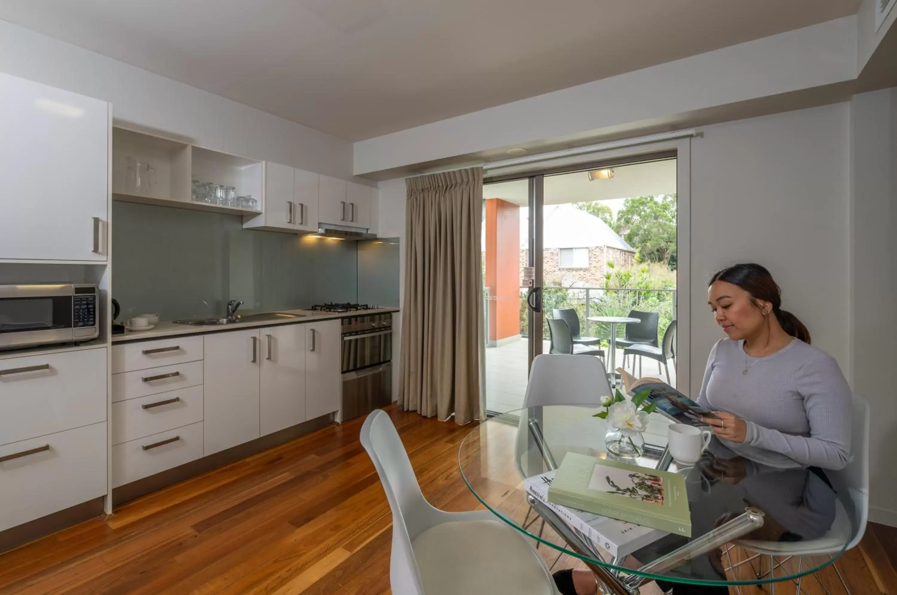 People, Kitchen/Kitchenette in Essence Apartments Chermside