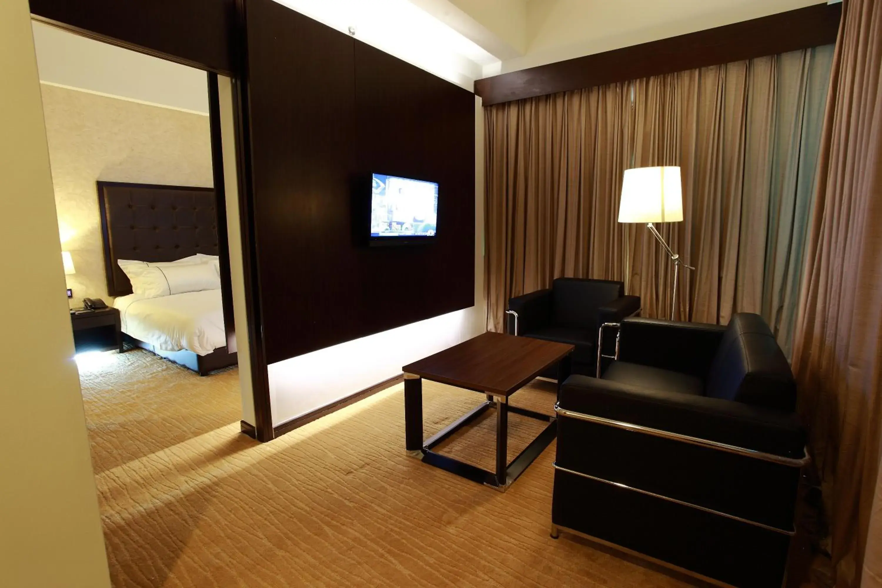 Living room, TV/Entertainment Center in Symphony Suites Hotel