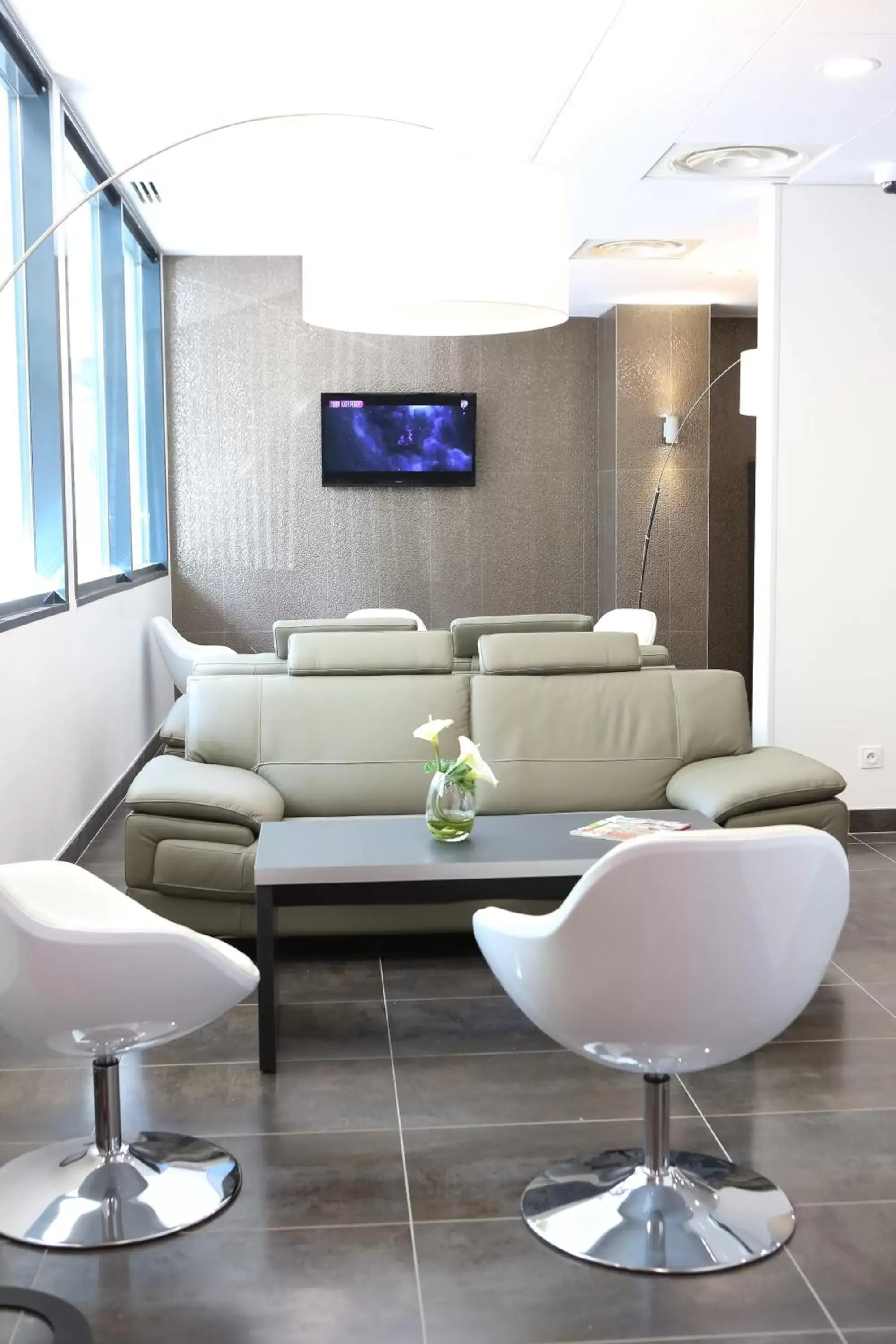 TV and multimedia, Seating Area in All Suites Appart Hôtel Aéroport Paris Orly – Rungis