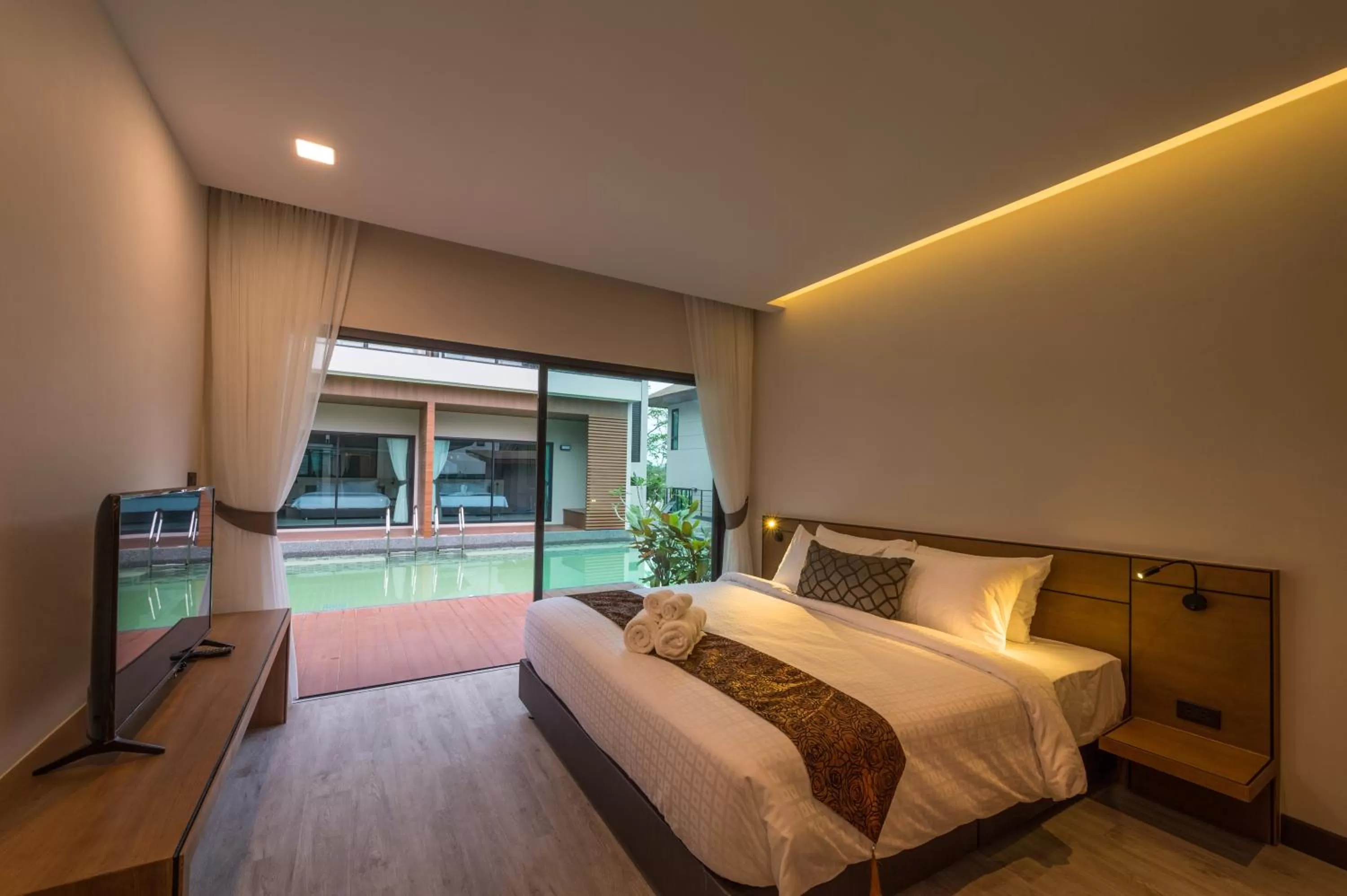 Bed in Cher​mantra​ Aonang​ Resort & Pool​ Suite