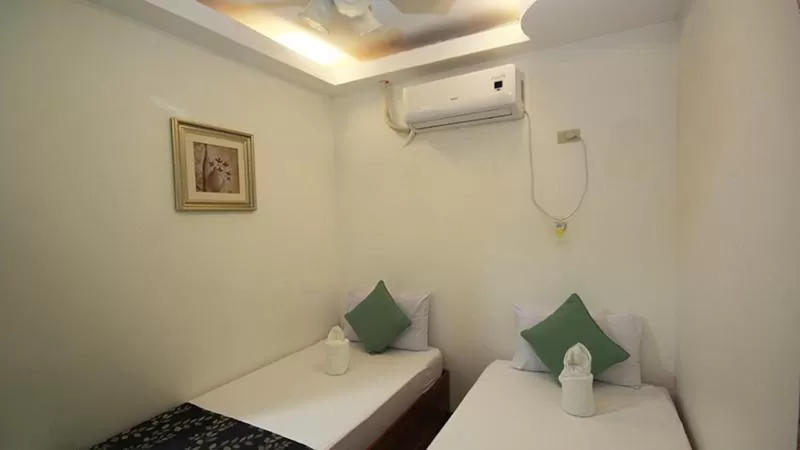Bed in El Nido Royal Palm Inn