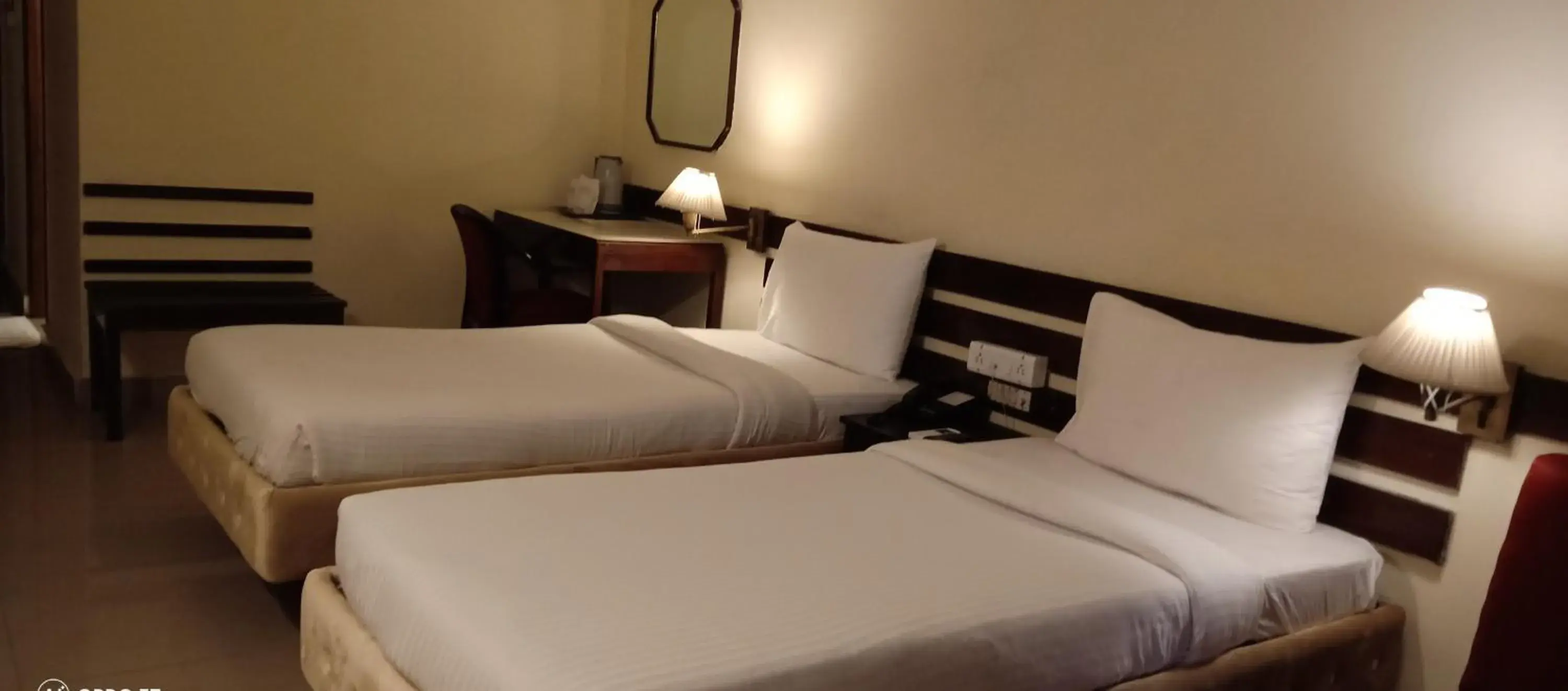 Bed in Hotel Poonja International