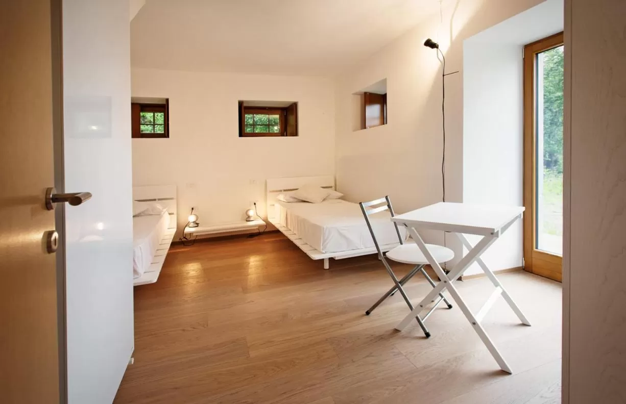 Photo of the whole room, Bed in Albergo Diffuso Tolmezzo