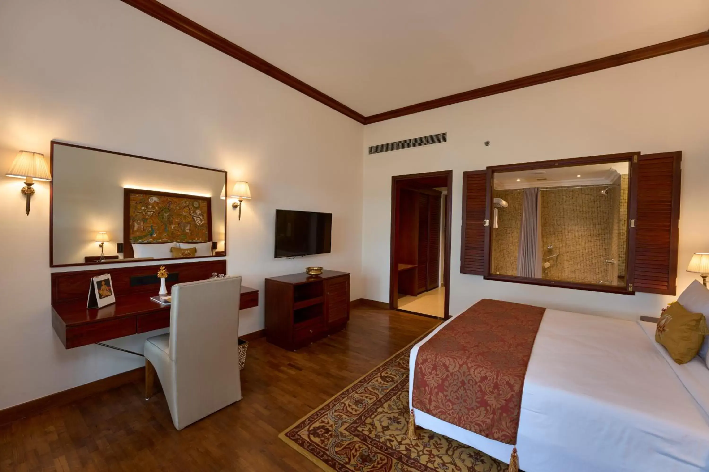 Bed, TV/Entertainment Center in The Leela Ashtamudi, A Raviz Hotel