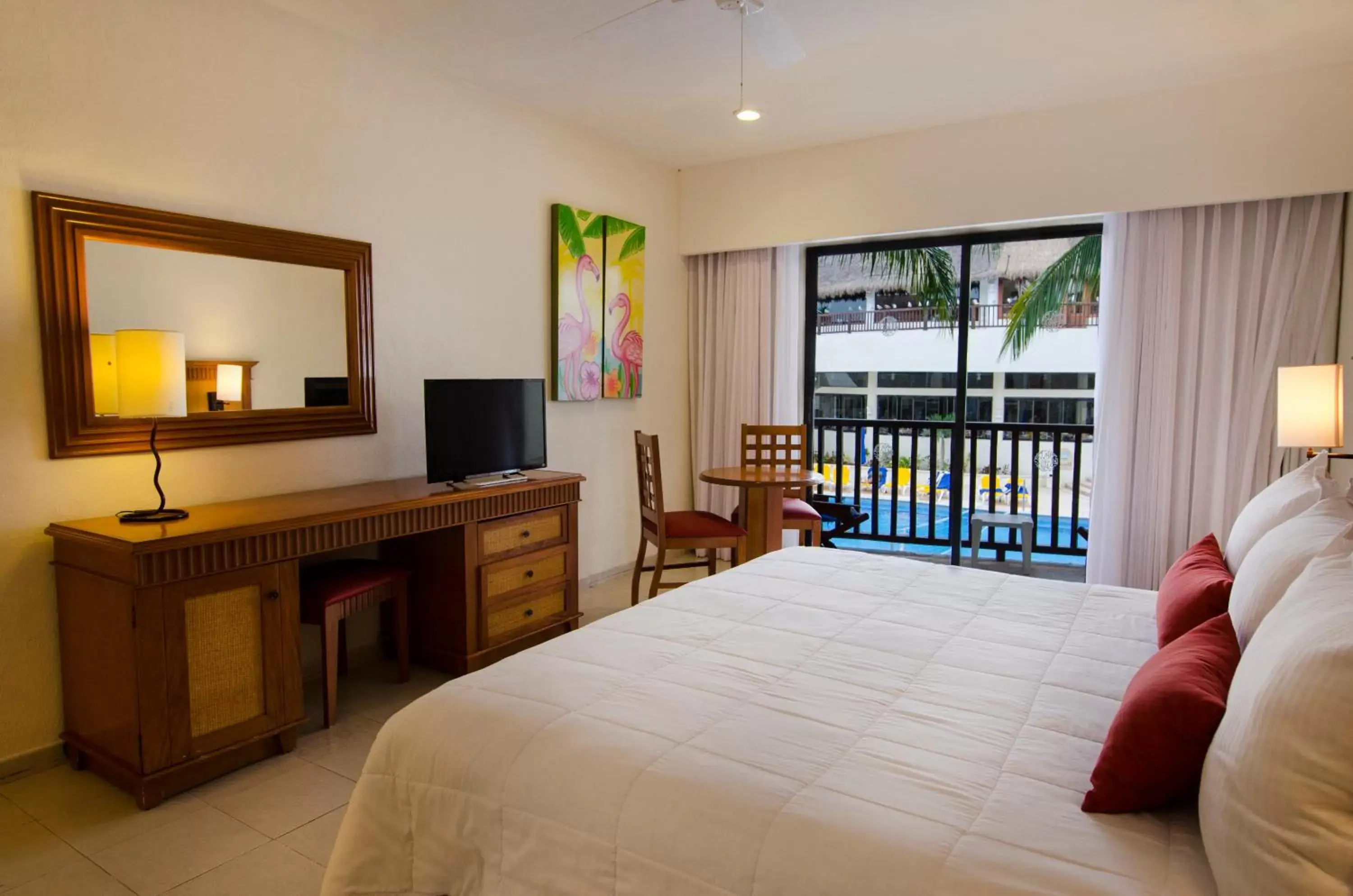 Bed, TV/Entertainment Center in The Reef Coco Beach & Spa- Optional All Inclusive