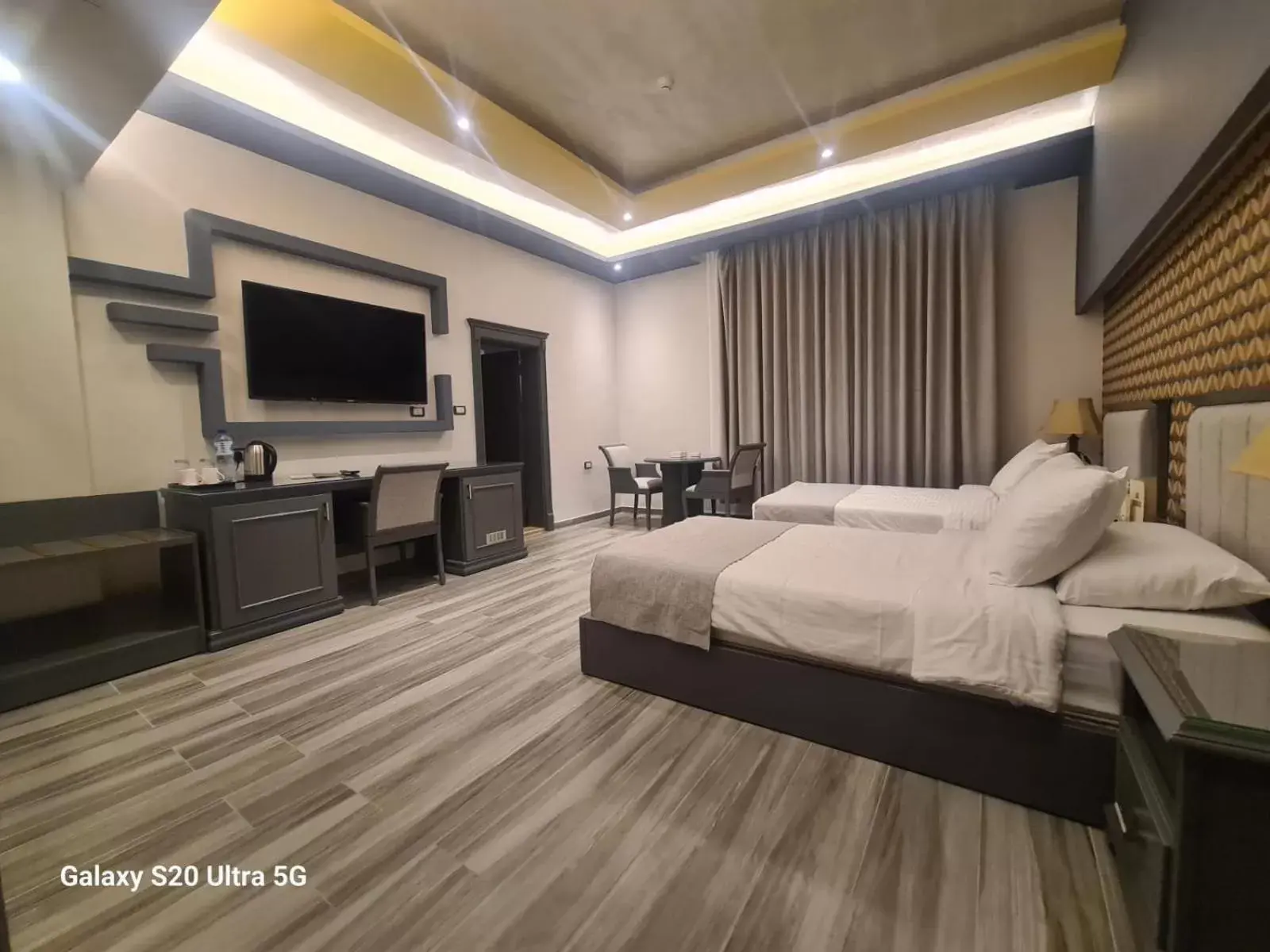 Communal lounge/ TV room, Bed in Hisham Hotel