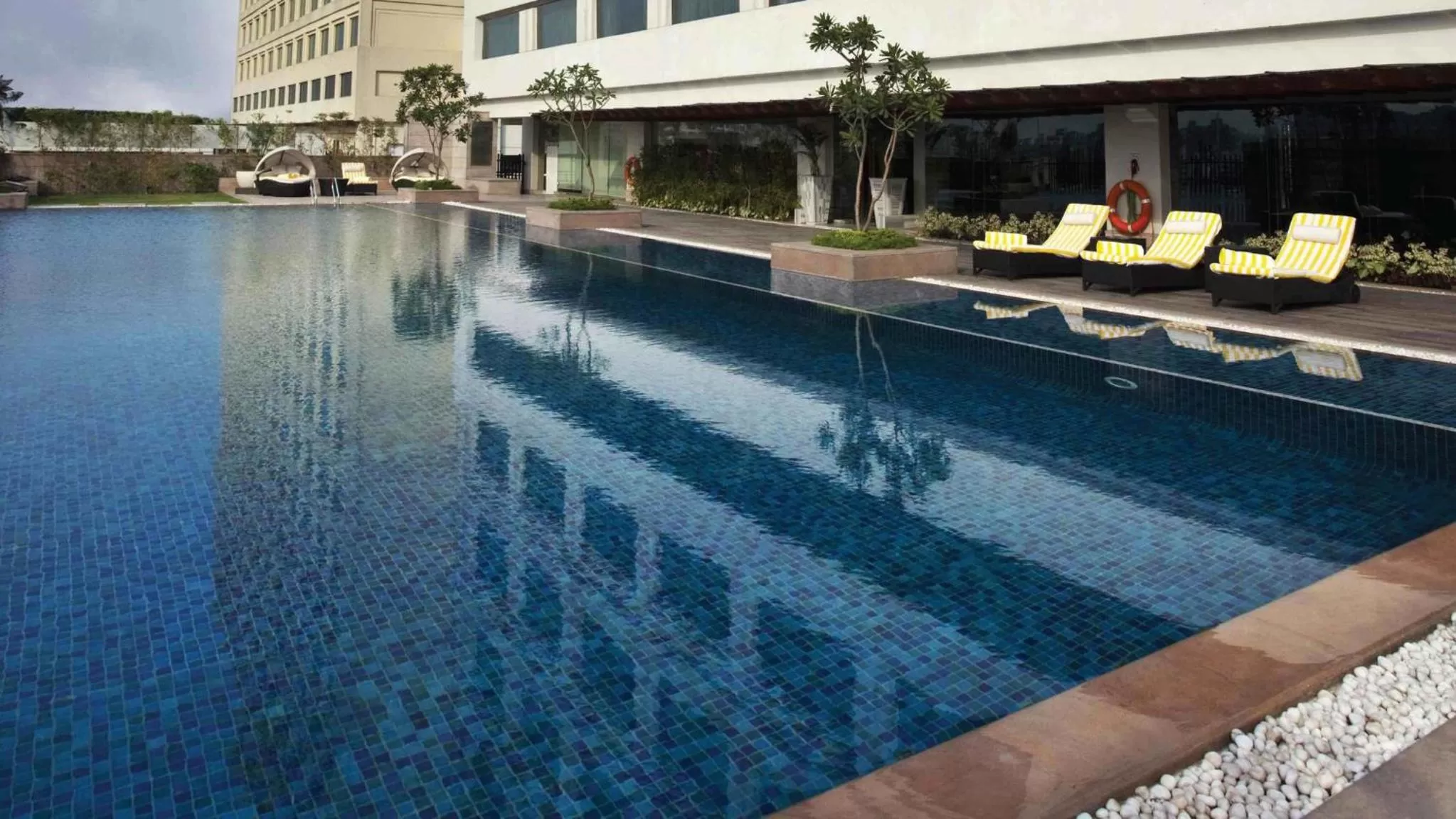 Swimming pool in Crowne Plaza New Delhi Mayur Vihar Noida by IHG