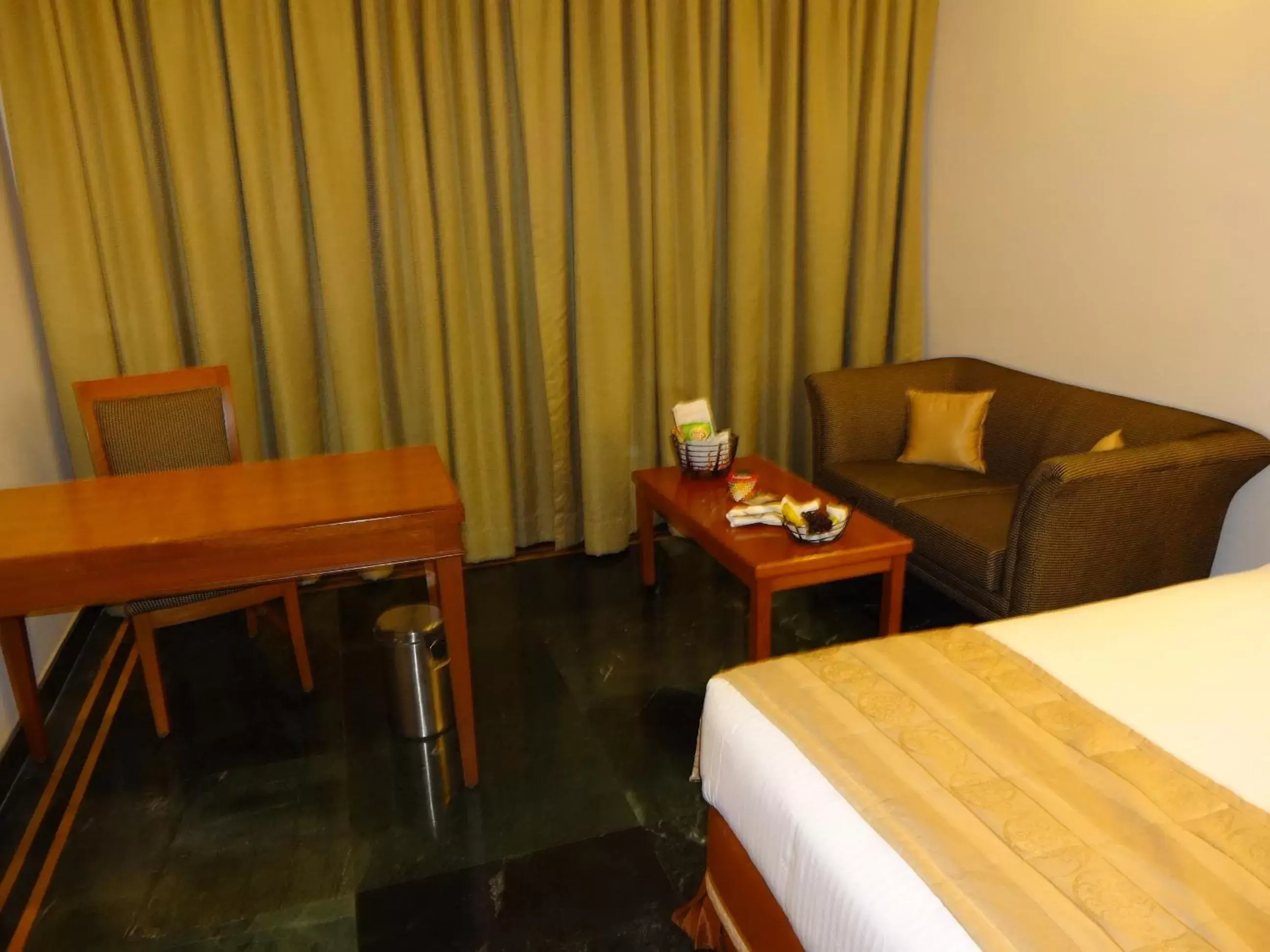 Bed, Seating Area in Regency Madurai by GRT Hotels