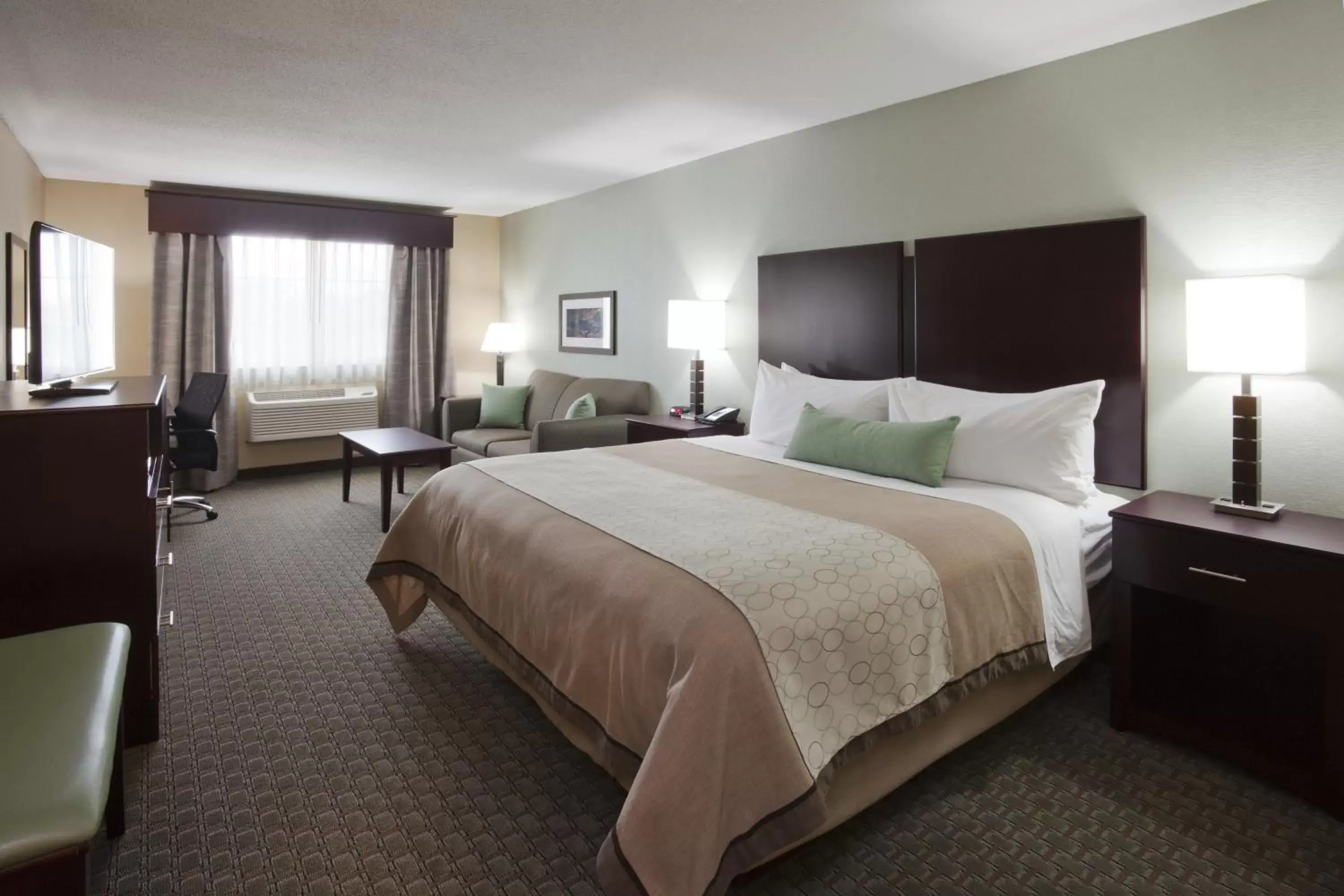 Bed in GrandStay Hotel & Suites - Glenwood