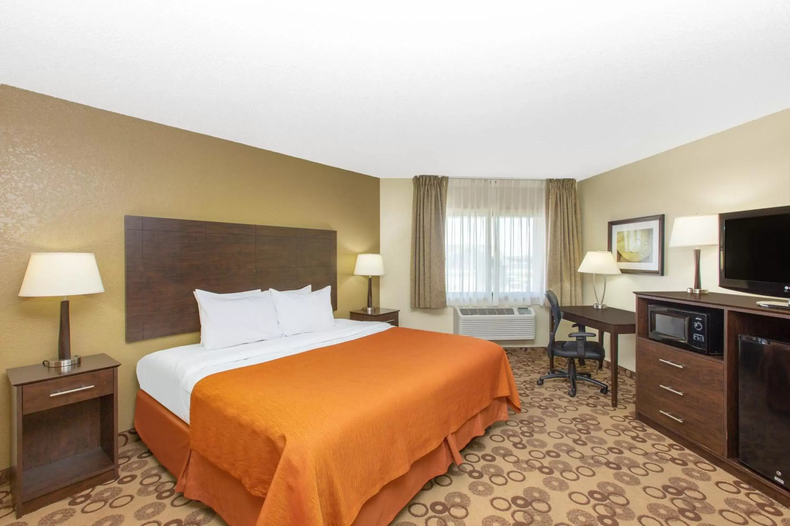 Bed in AmericInn by Wyndham Cedar Falls