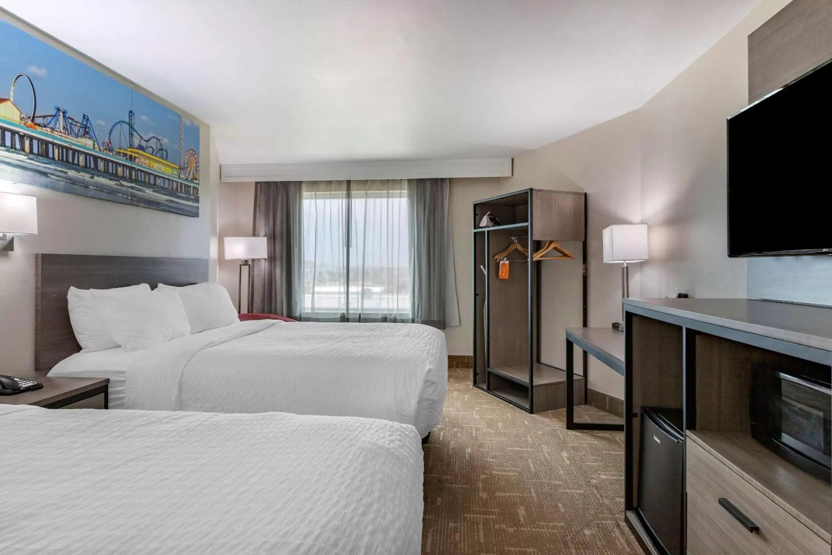 Bed, TV/Entertainment Center in Clarion Pointe Galveston Seawall