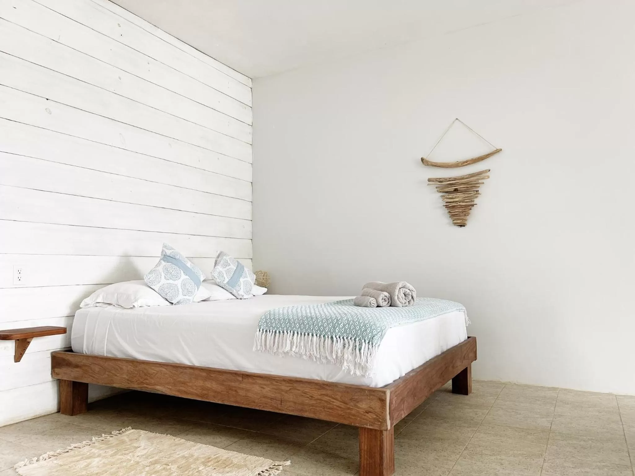 Bed in Bird Island Bungalows