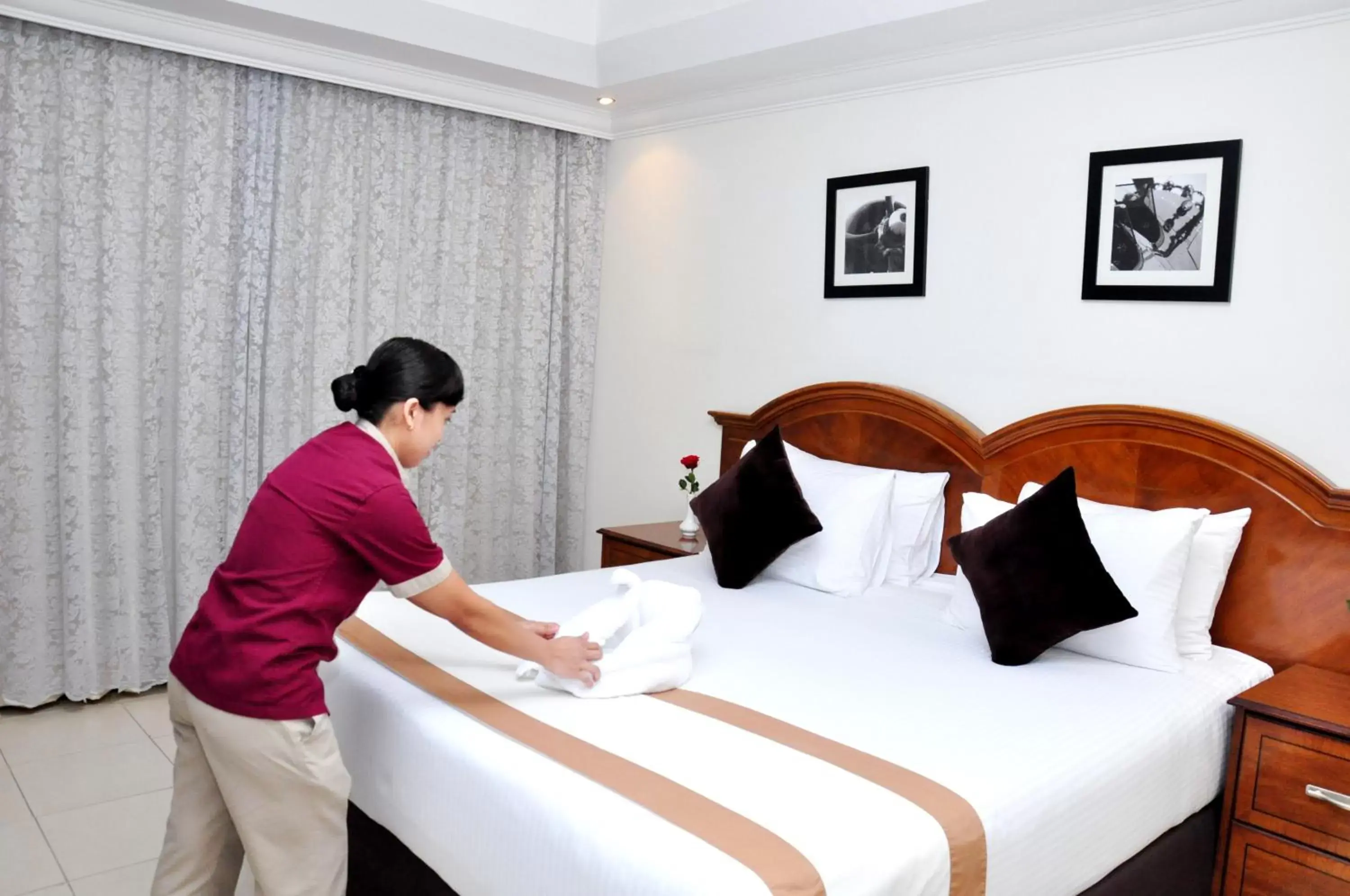 Bed, Staff in Ewan Ajman Suites Hotel