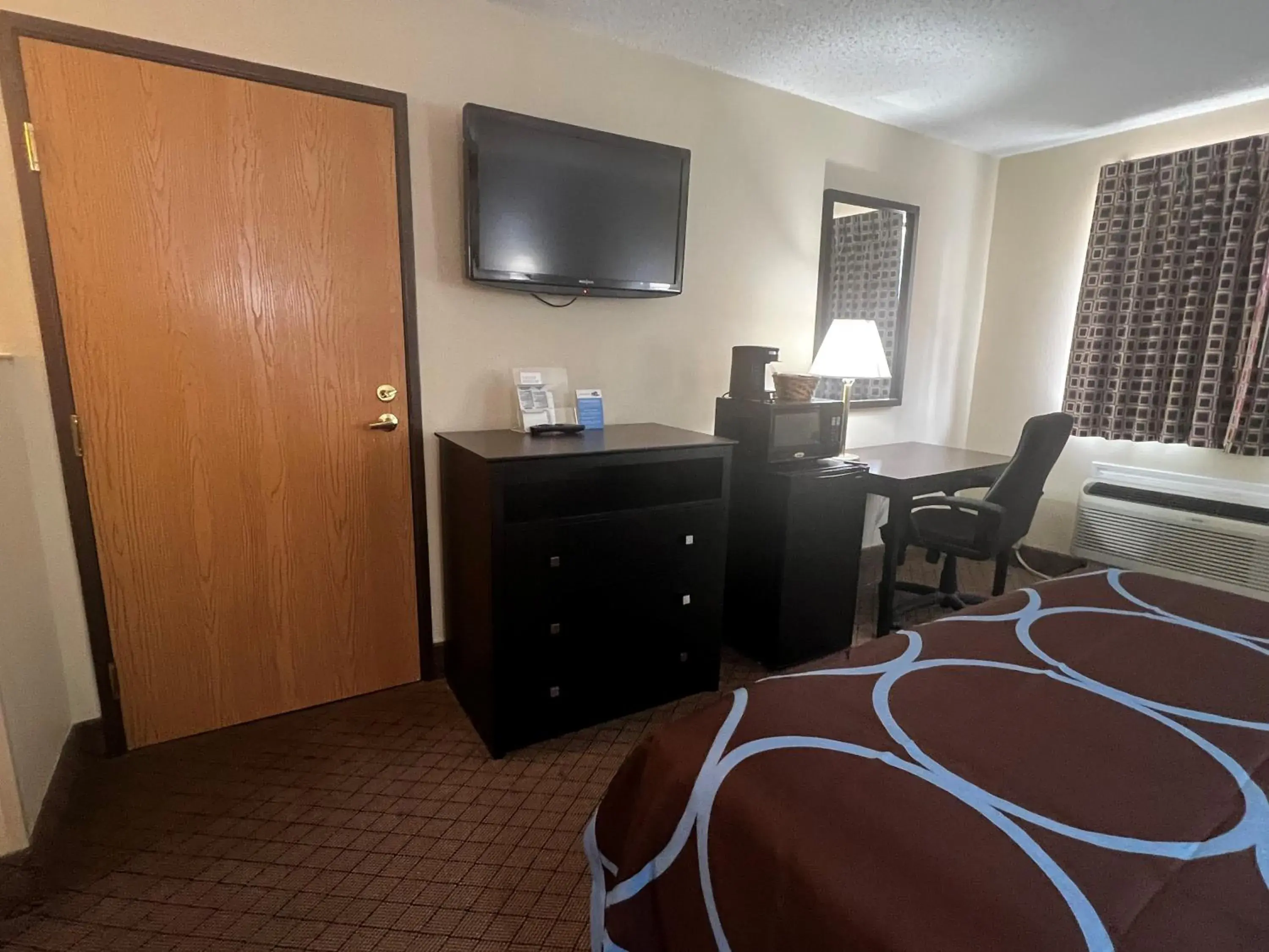 Photo of the whole room, TV/Entertainment Center in Super 8 by Wyndham Cleveland TX