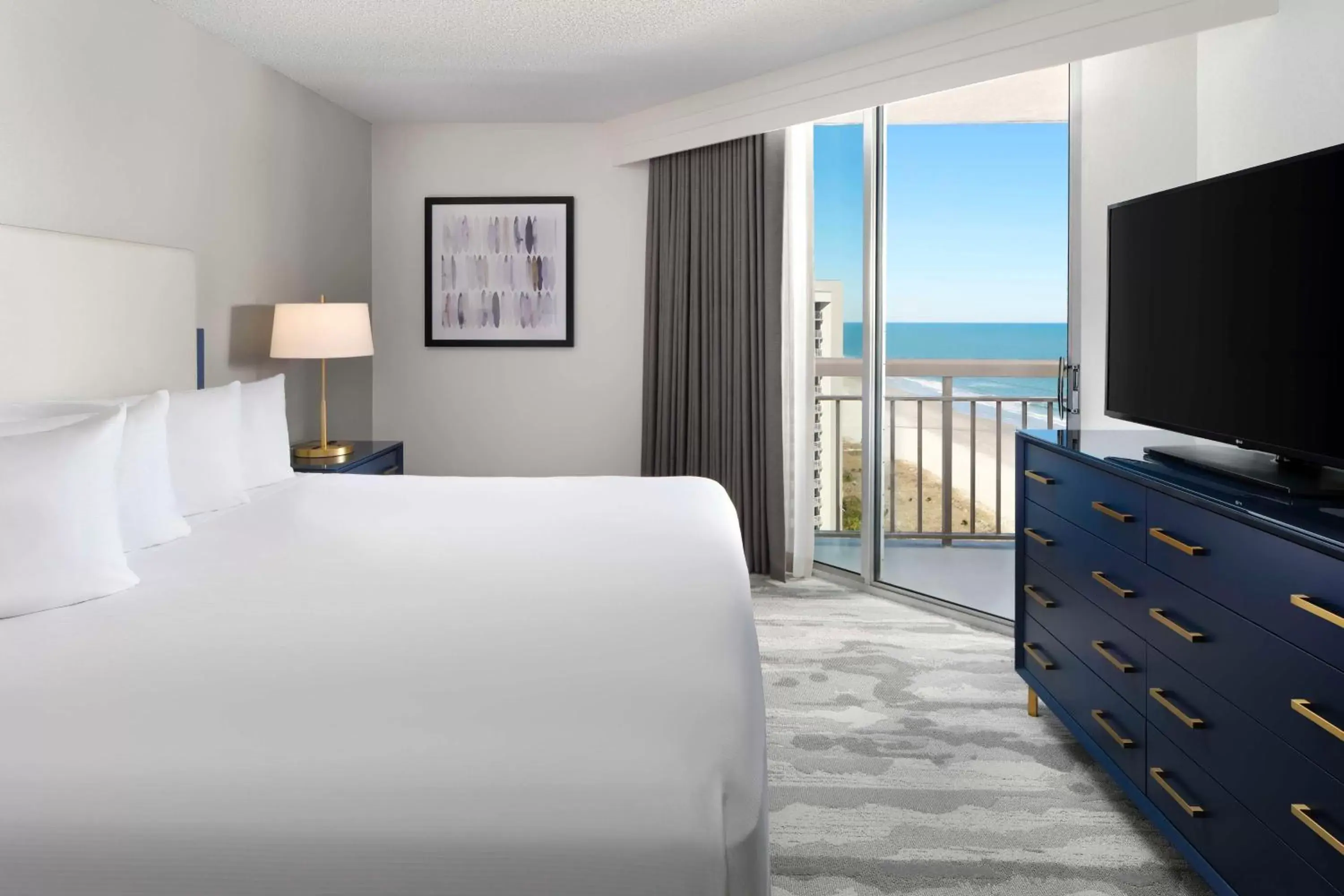 Bed, TV/Entertainment Center in Embassy Suites by Hilton Myrtle Beach Oceanfront Resort