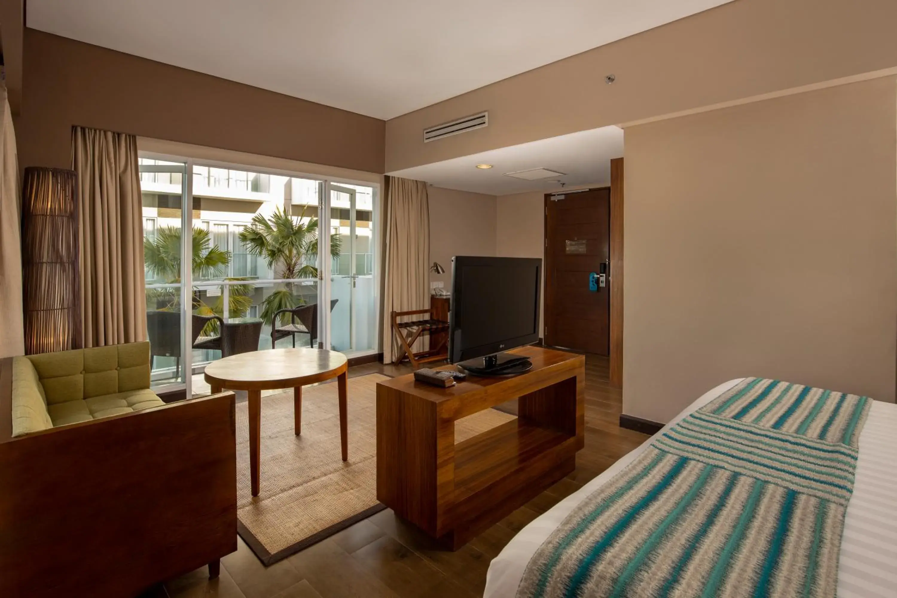 Bed, TV/Entertainment Center in Grand Ixora Kuta Resort