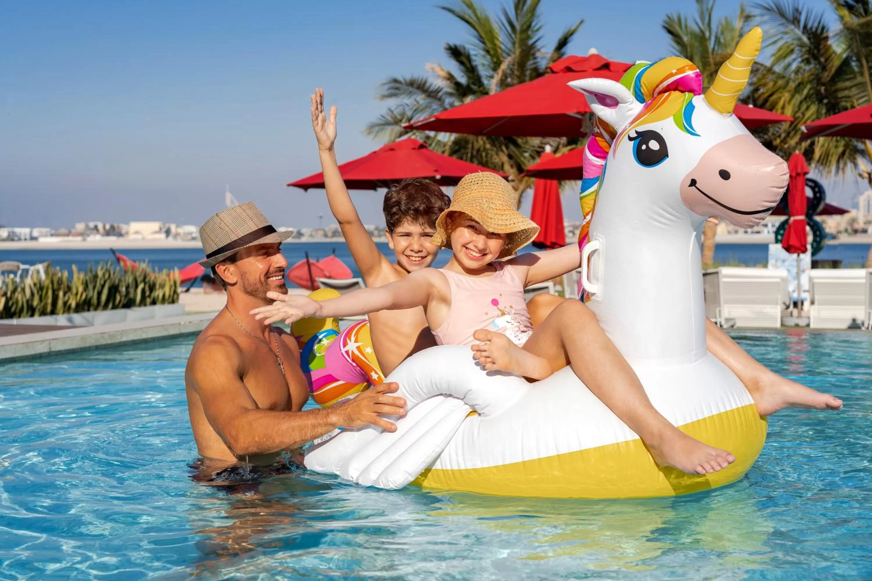 Swimming pool in Th8 Palm Dubai Beach Resort Vignette Collection, an IHG hotel