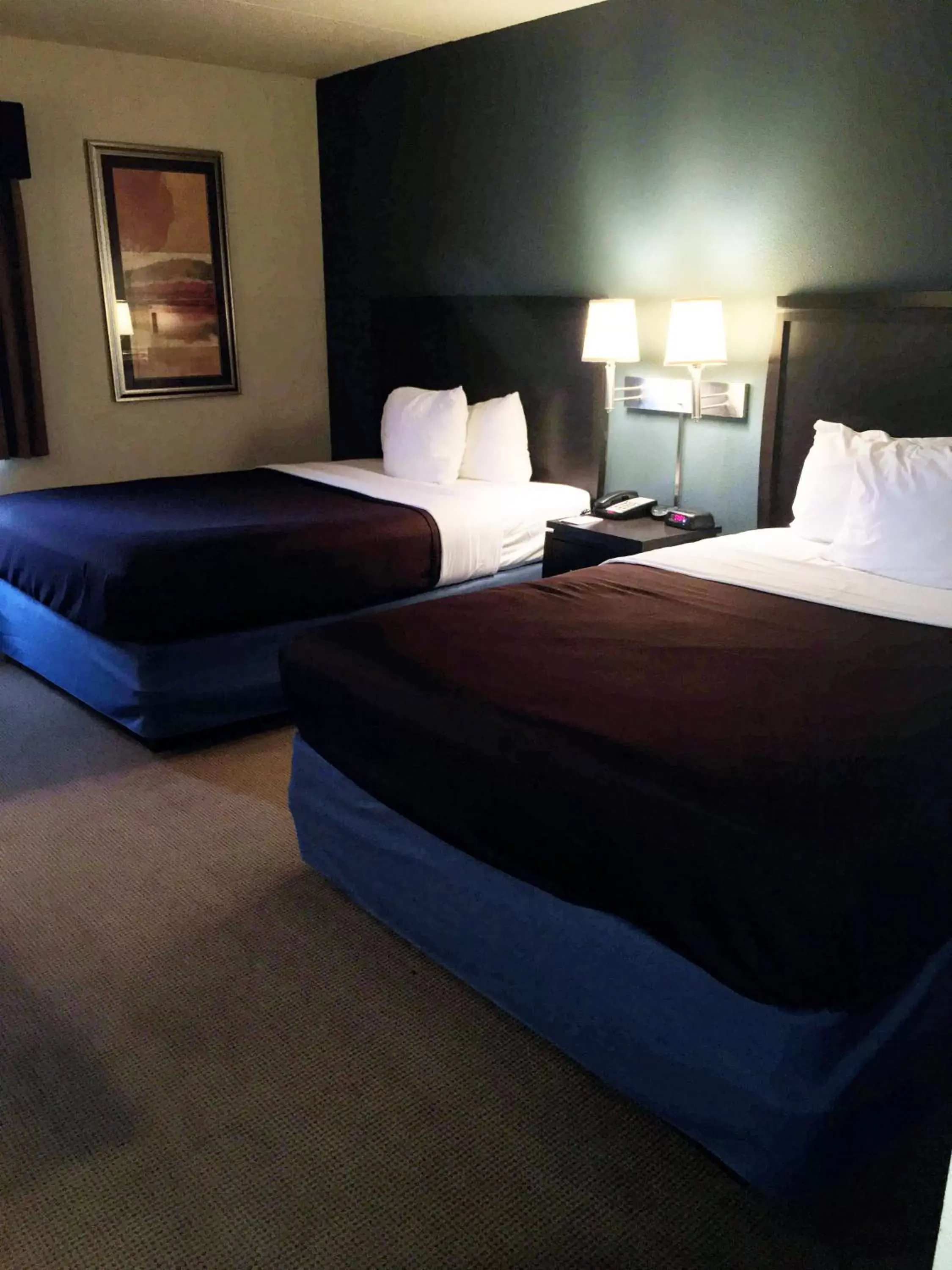 Bed in AmericInn by Wyndham Monmouth