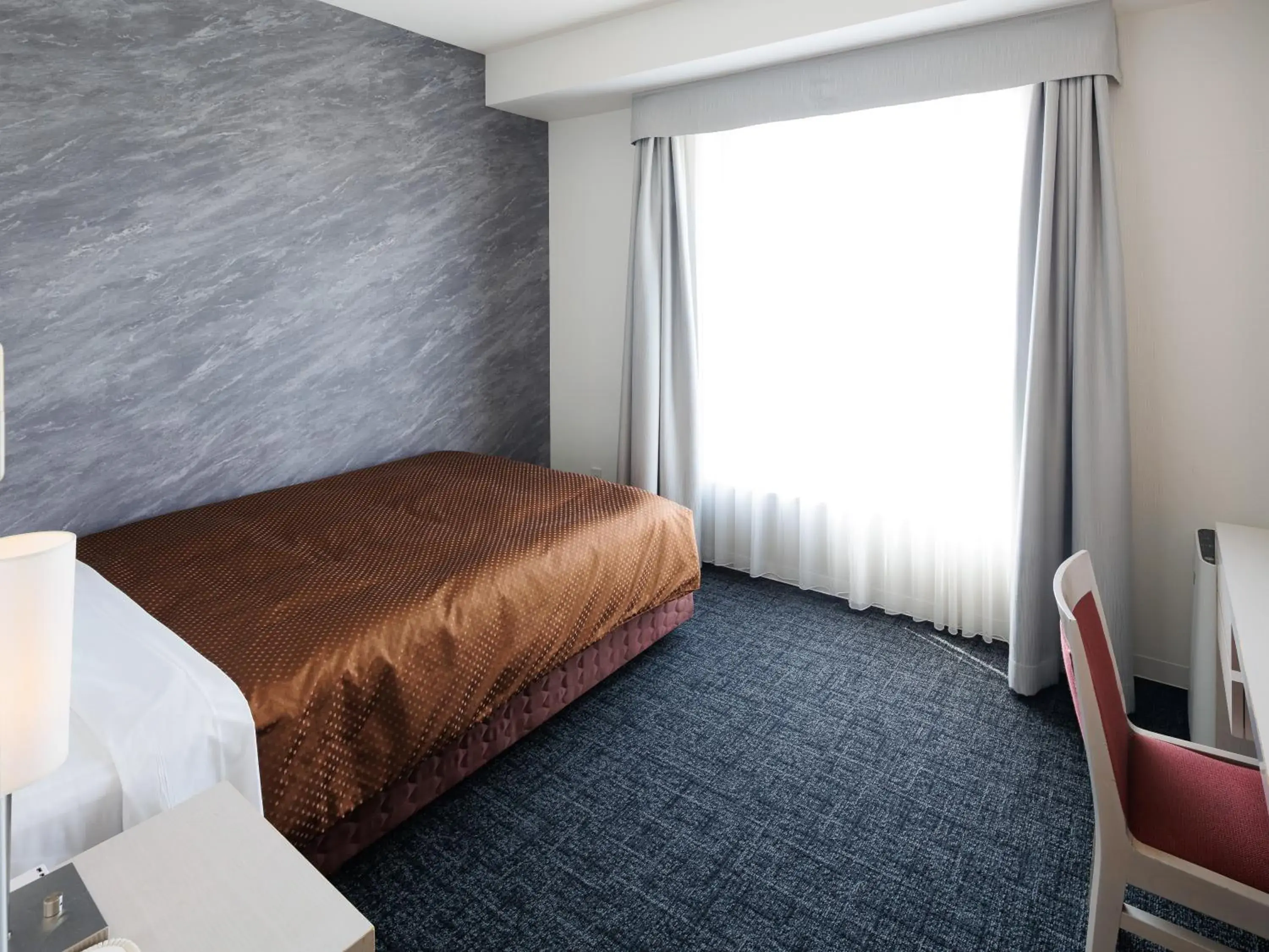 Photo of the whole room, Bed in J Hotel Rinku