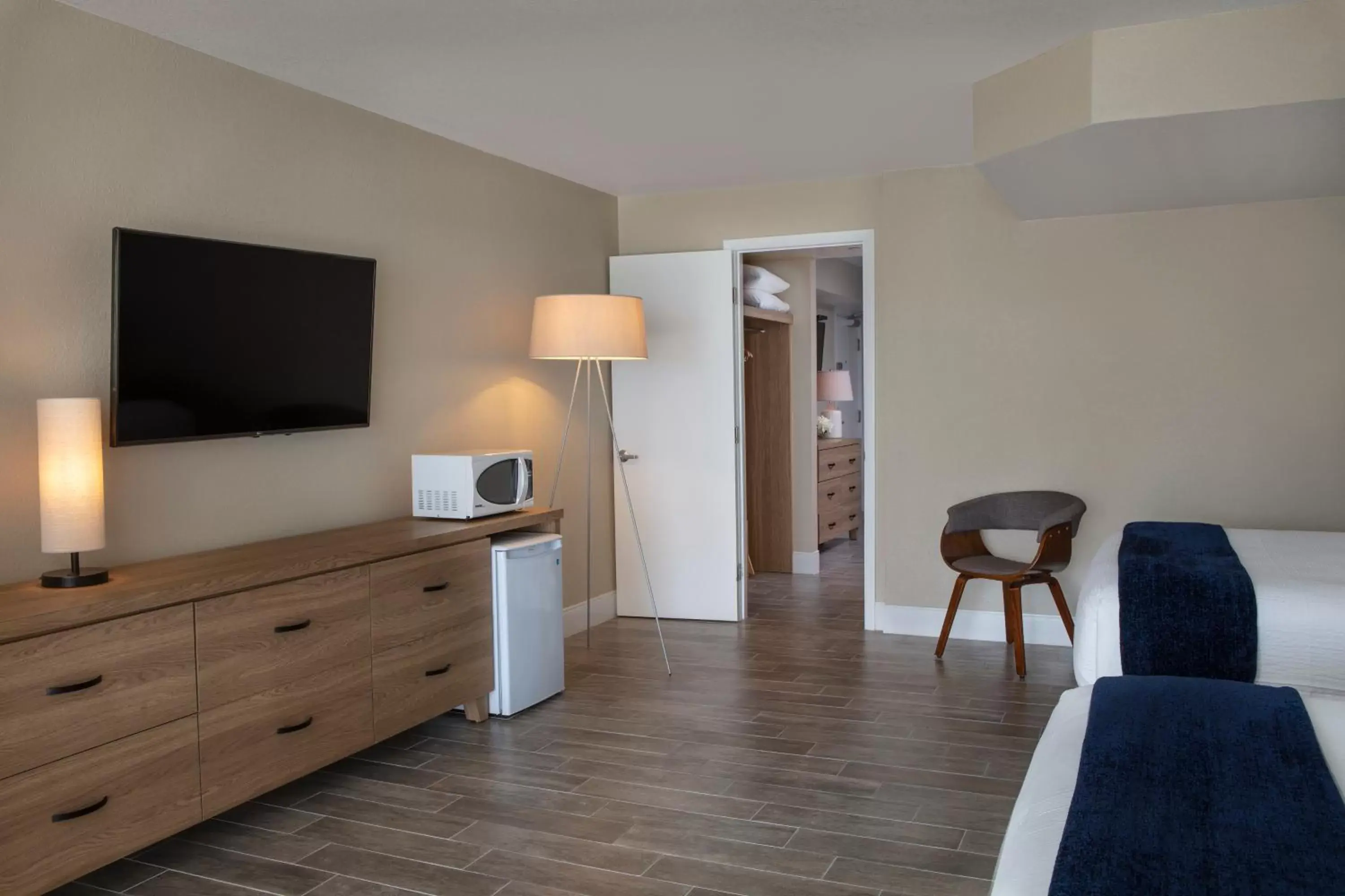 Bed, TV/Entertainment Center in Postcard Inn Beach Resort & Marina